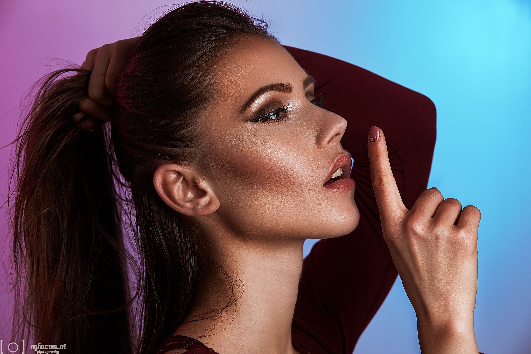 Woman with hand on head and finger to lips HD Wallpaper