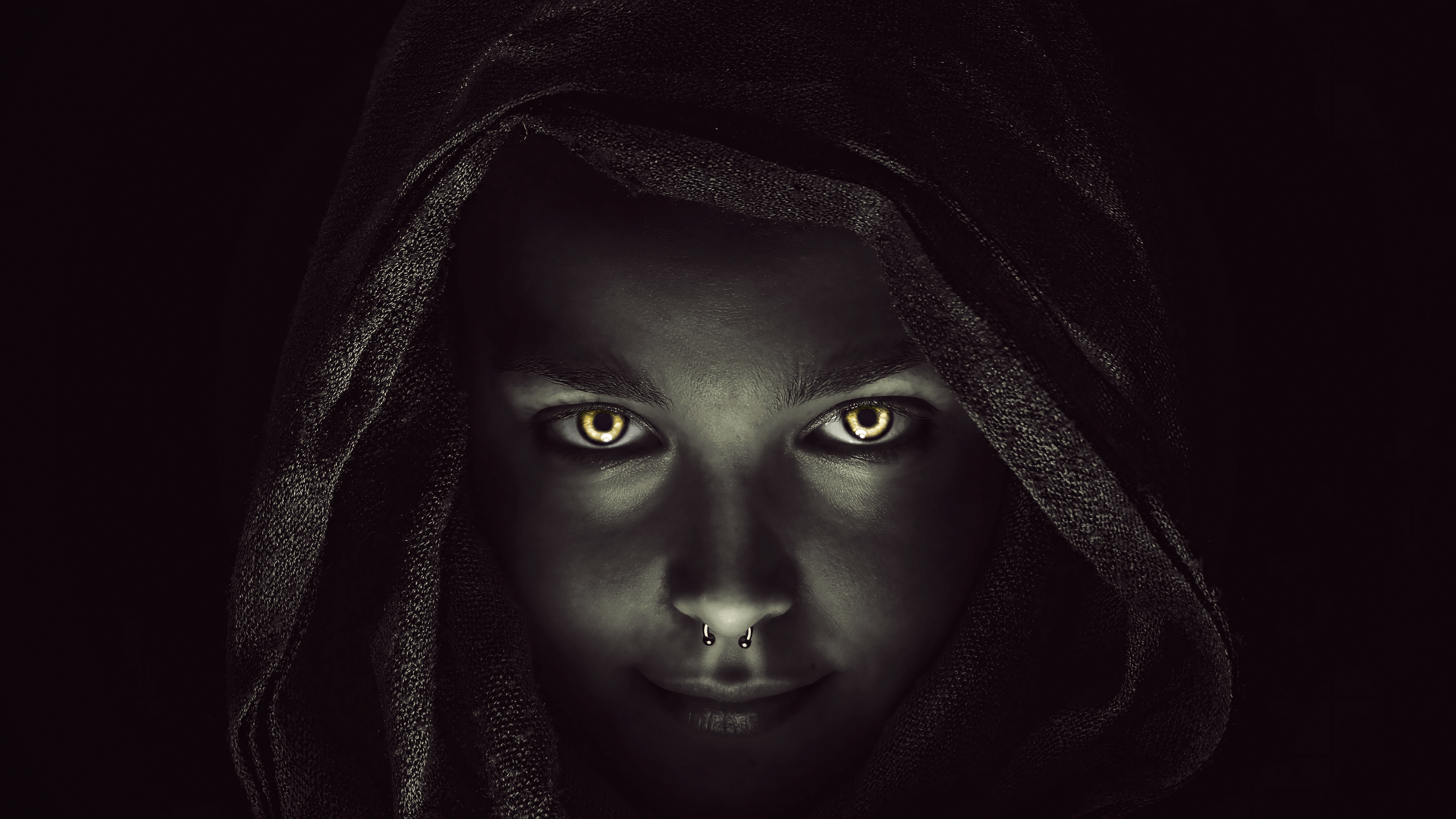 Woman with glowing eyes wearing a hood HD Wallpaper