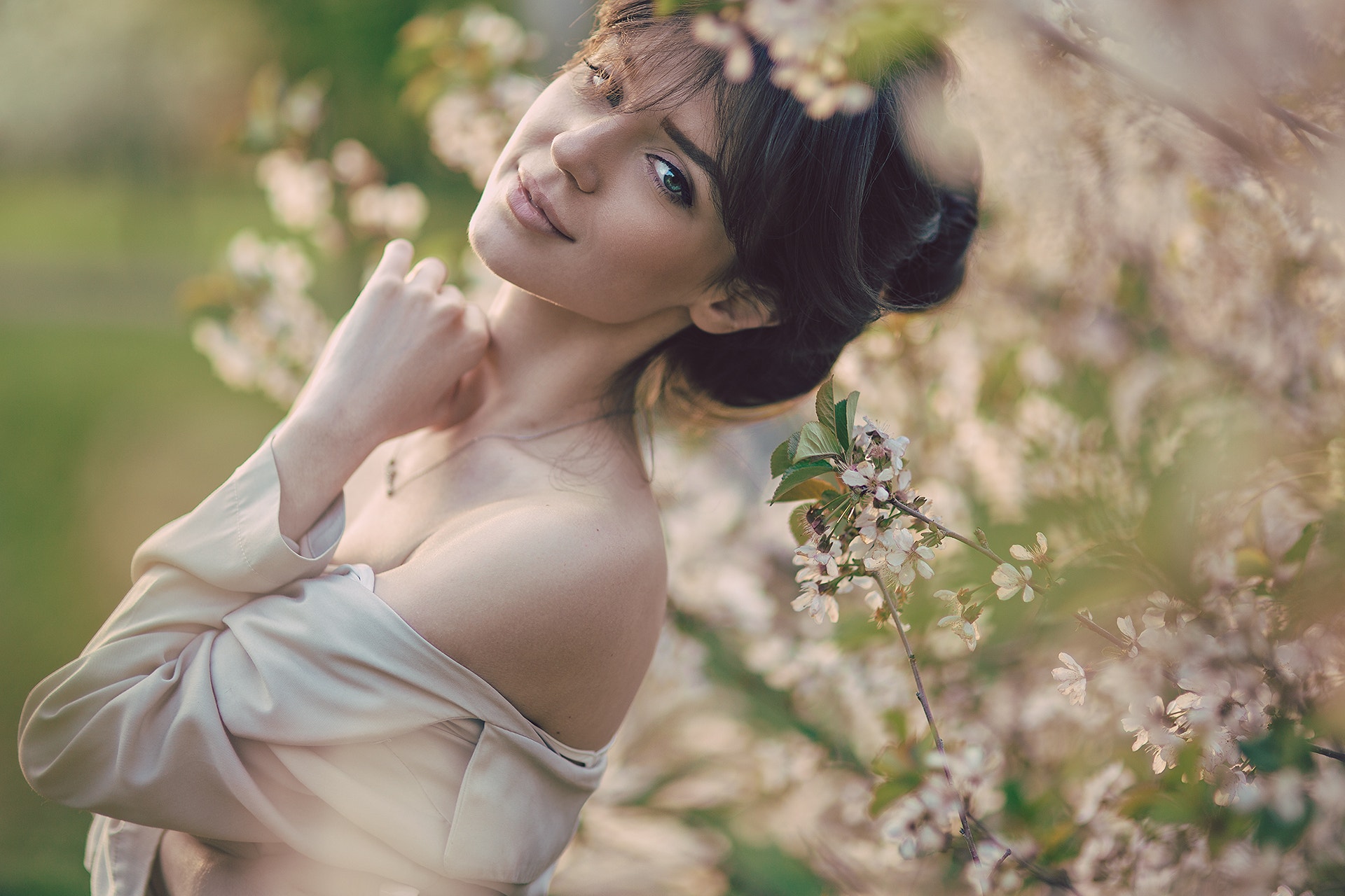 Portrait of a woman among blooming trees HD Wallpaper