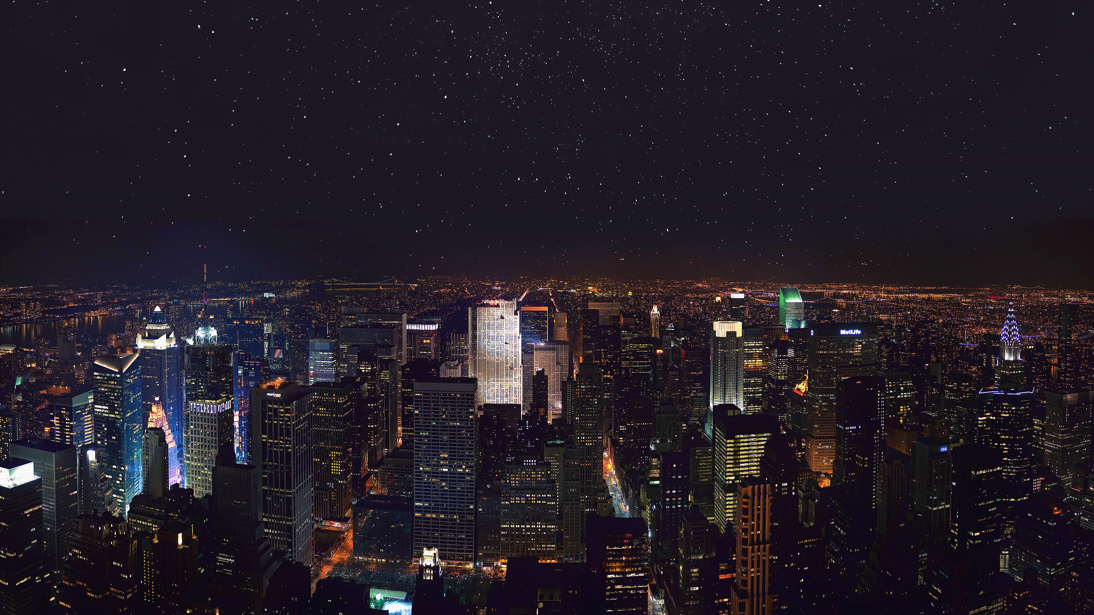 New York City skyline at night under a starry sky HD Wallpaper