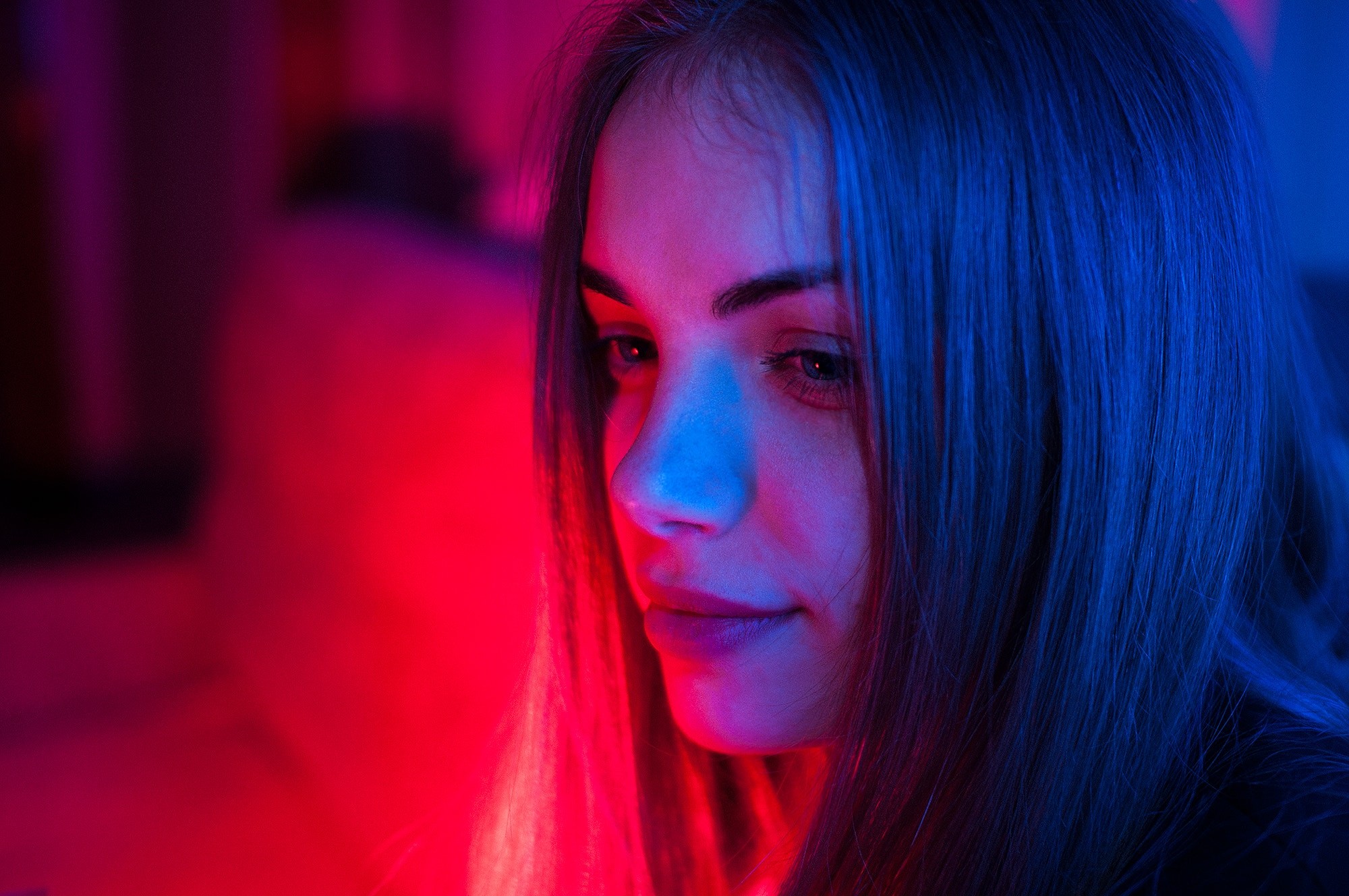 Portrait of a young woman with blue and red lighting HD Wallpaper