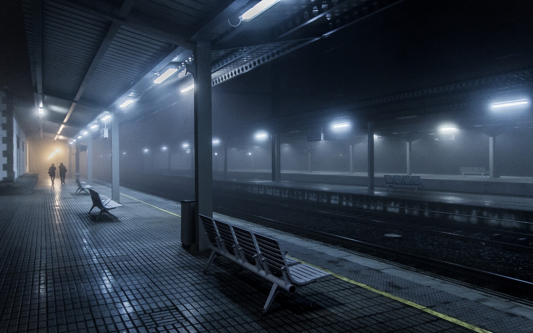 Train station platform at night with fog HD Wallpaper