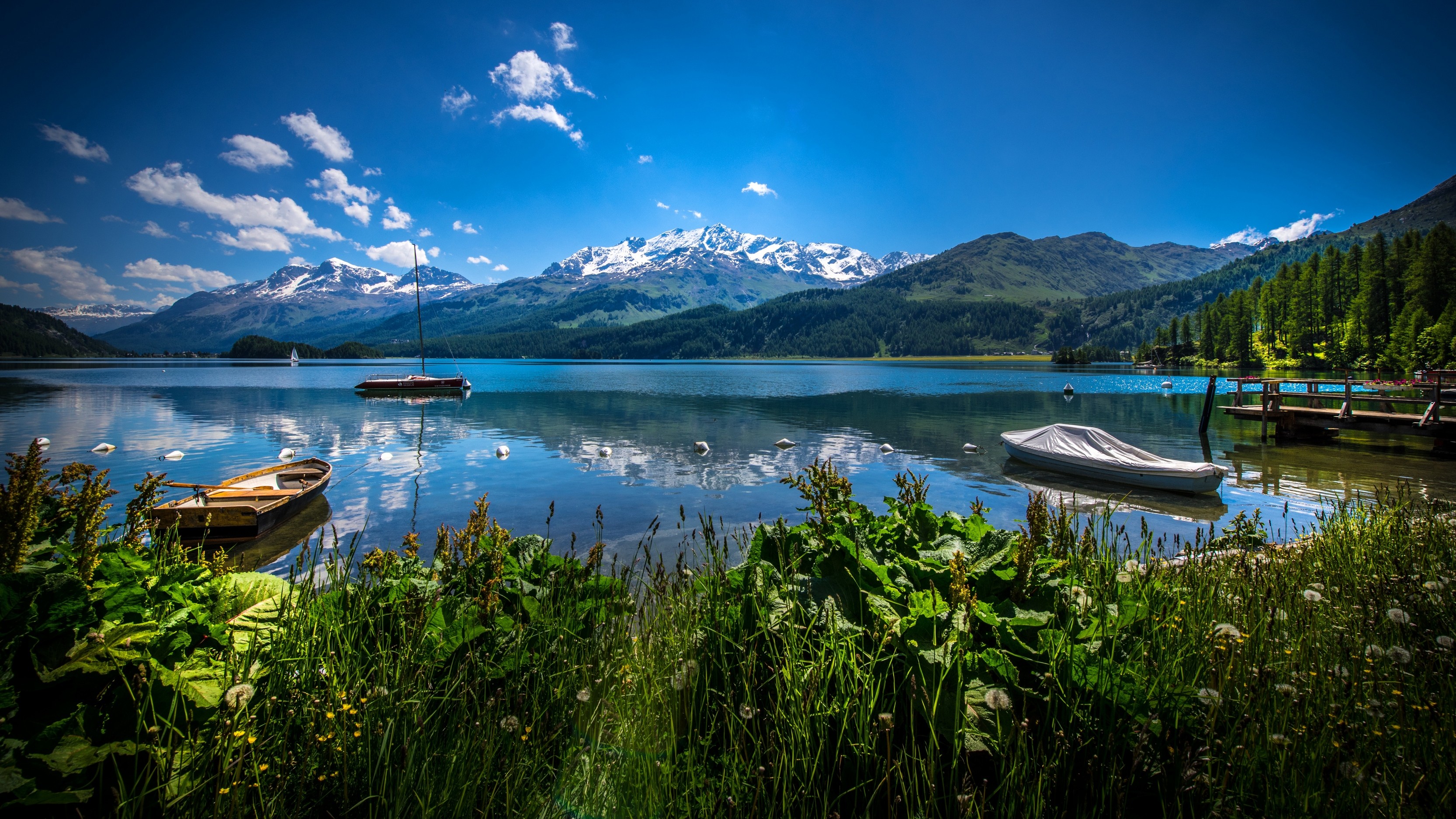 Lake with boats and snow-capped mountains HD Wallpaper