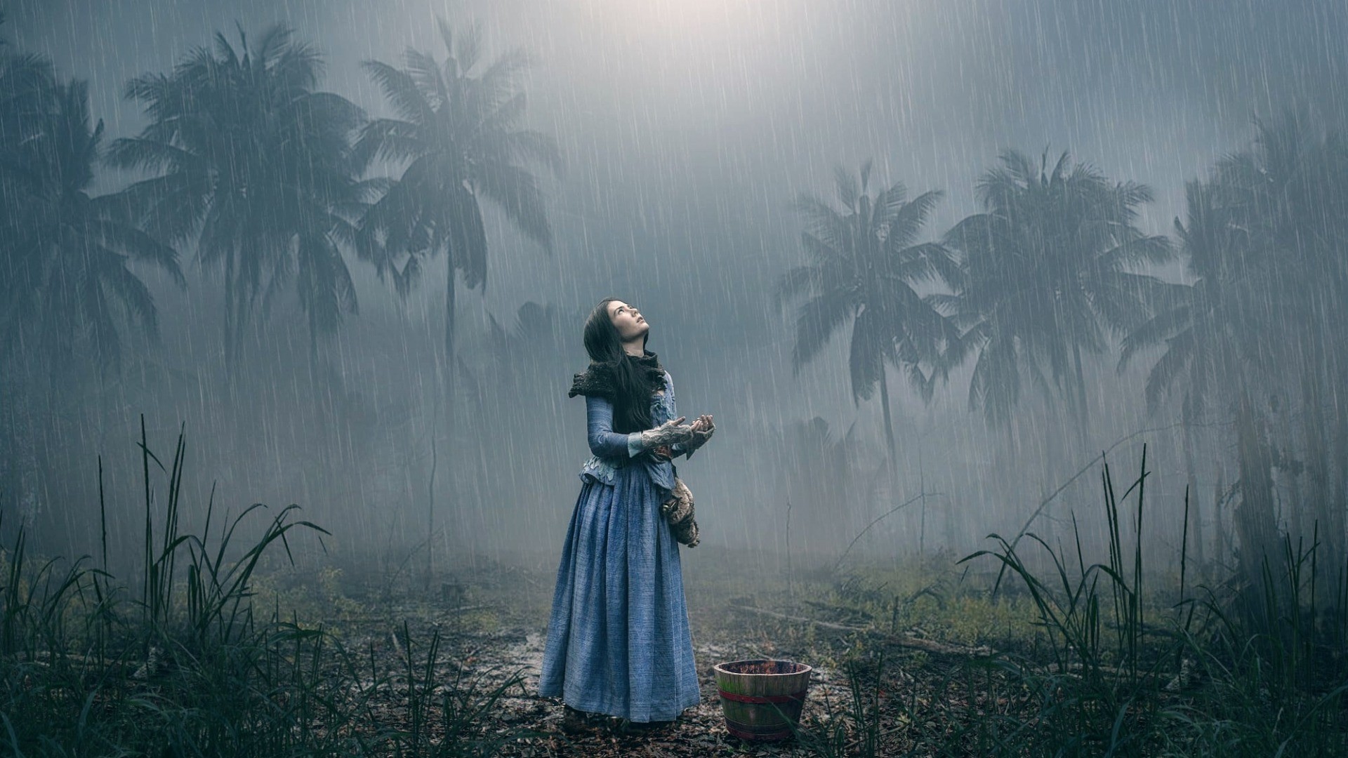 Woman in blue dress looking up in the rain HD Wallpaper
