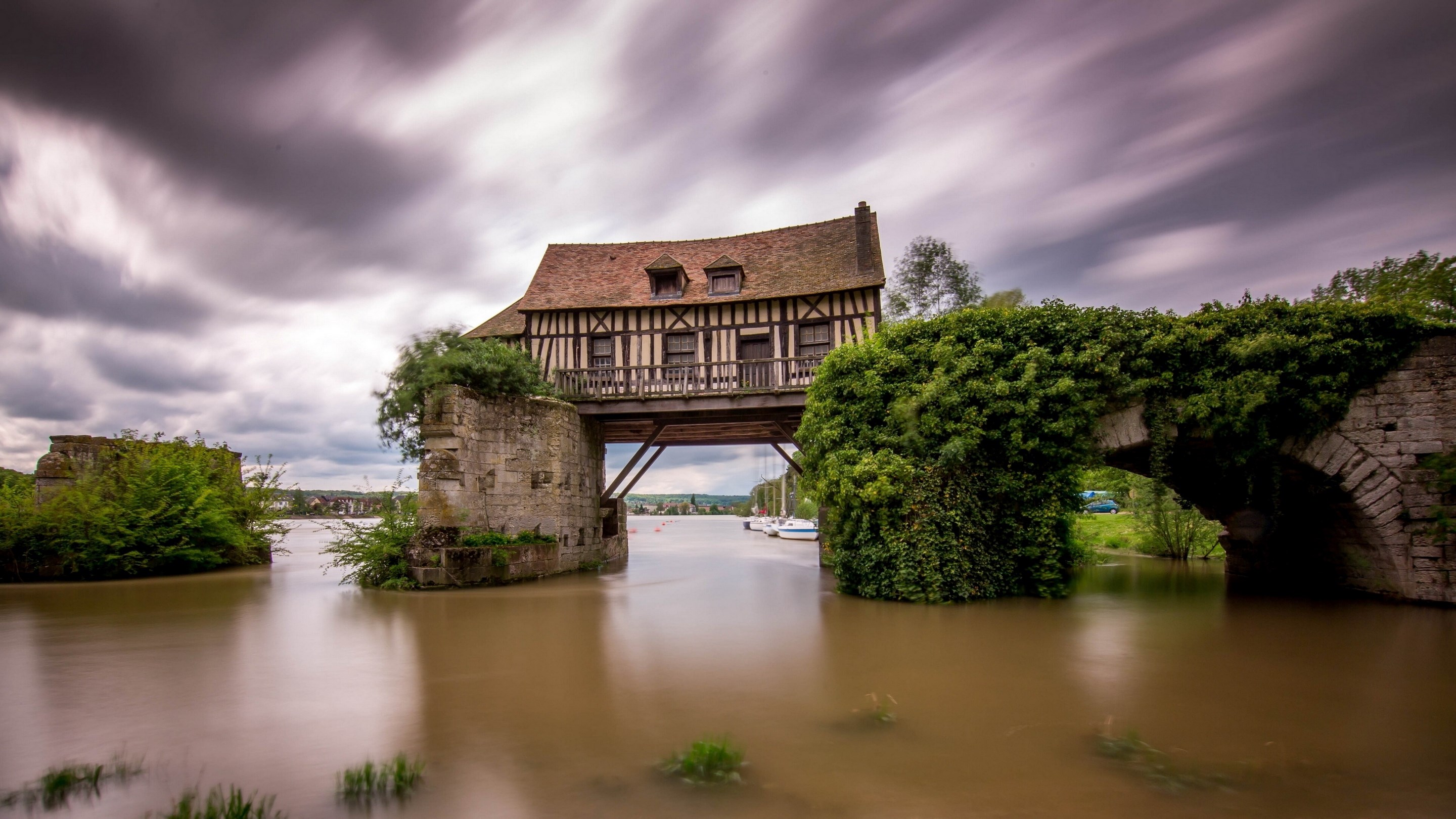Half-timbered house on a bridge over a river HD Wallpaper