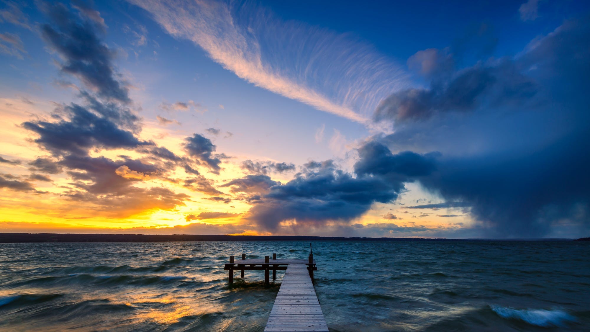 Wooden pier on a lake at sunset with dramatic clouds HD Wallpaper