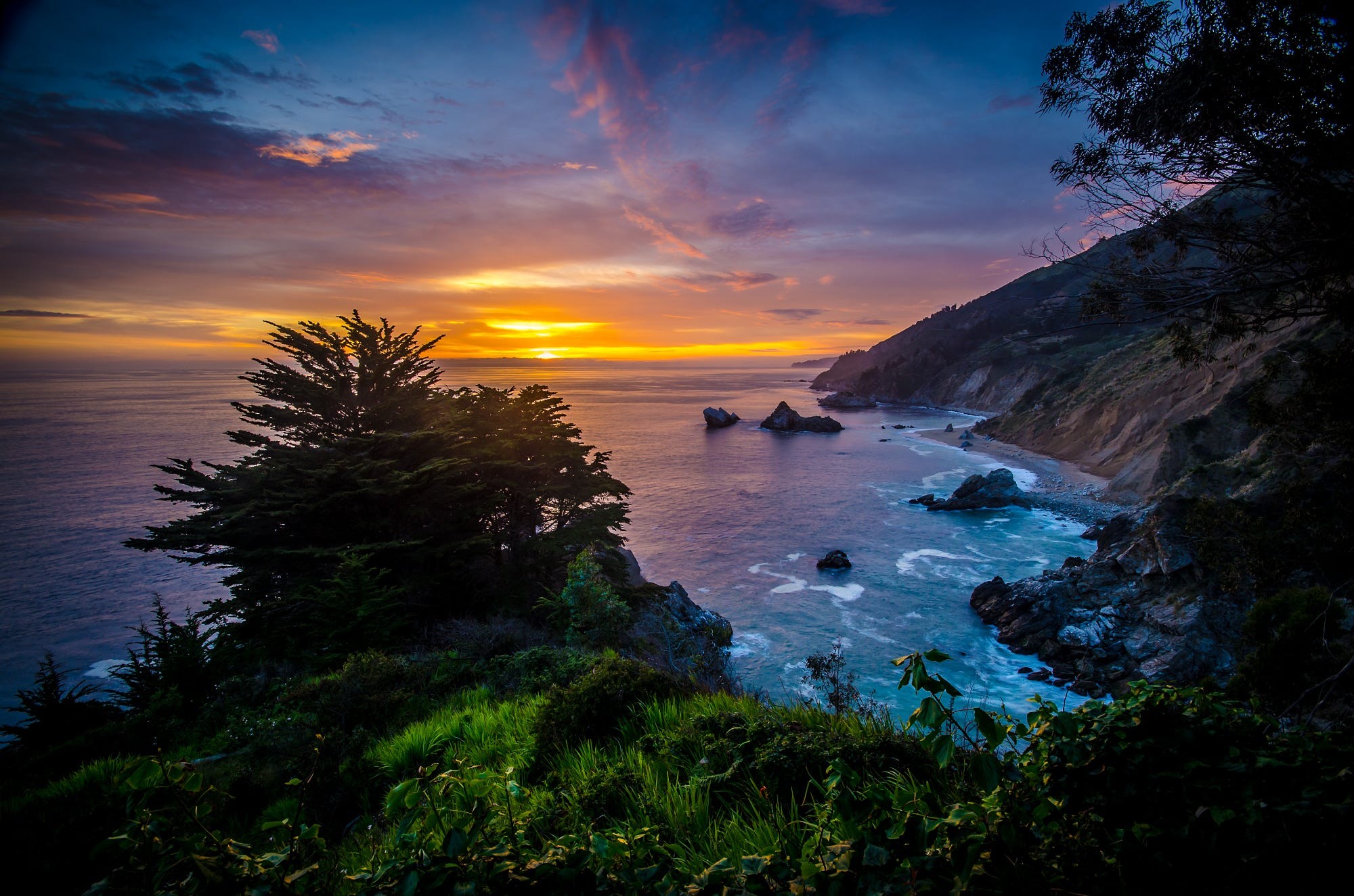 Sunset over the rocky coast with trees HD Wallpaper