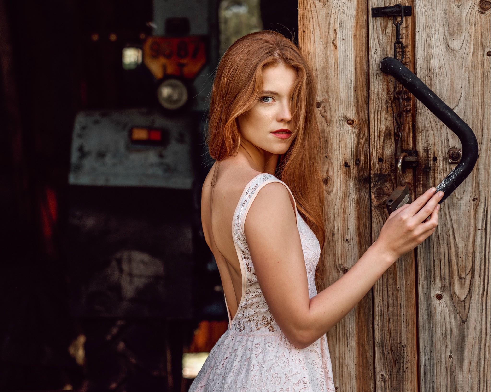 Redhead woman in white dress by wooden door HD Wallpaper