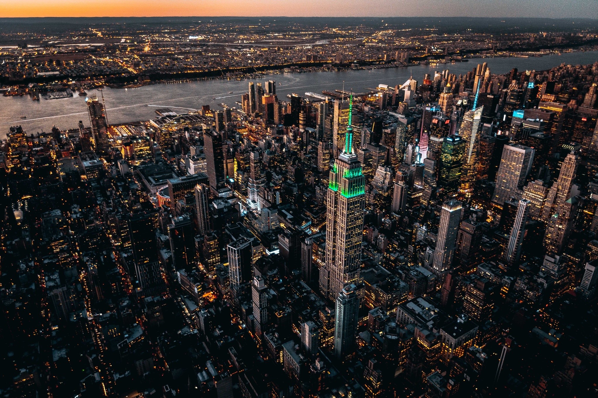 Empire State Building illuminated green at night, New York City cityscape HD Wallpaper