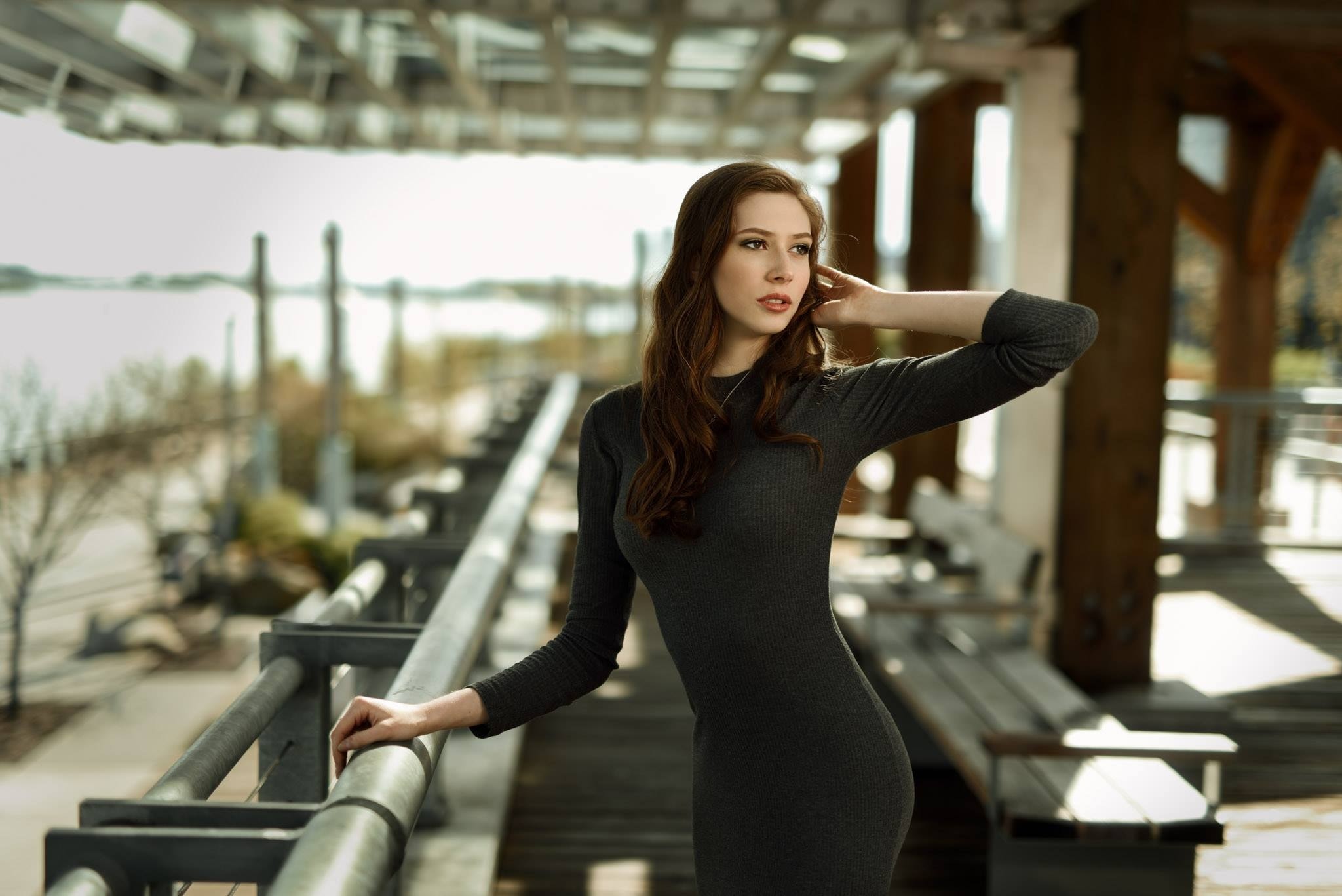 Woman in a dark dress standing outdoors HD Wallpaper