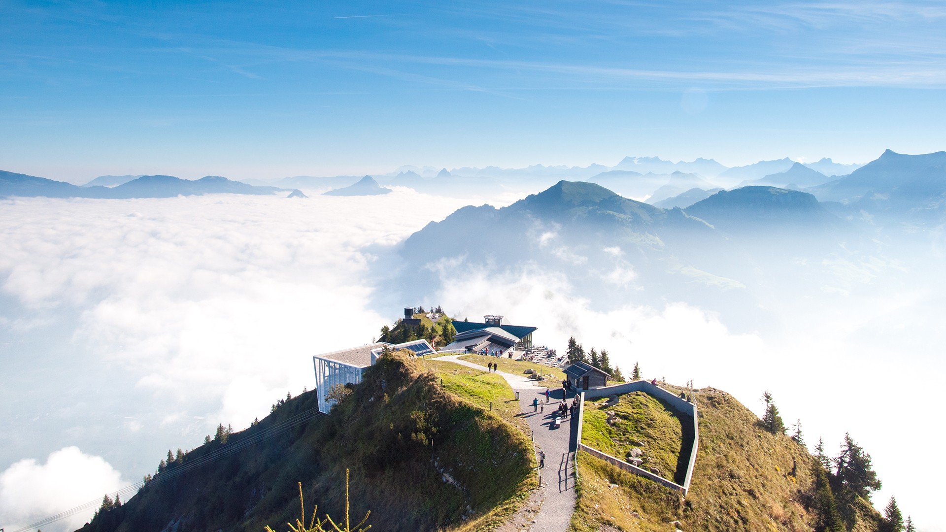 Mountain landscape with clouds and a building HD Wallpaper