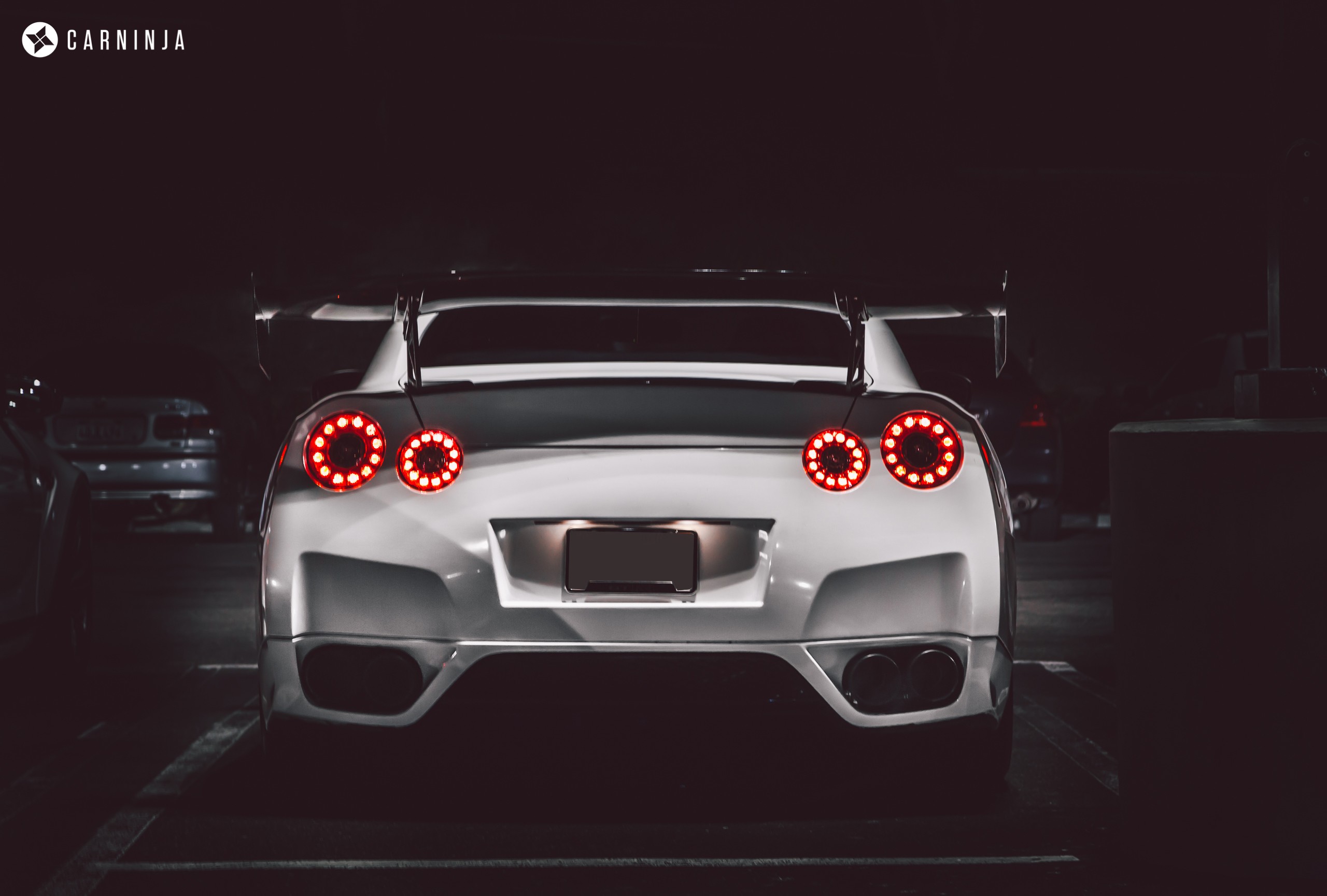 White Nissan GT-R with spoiler at night HD Wallpaper