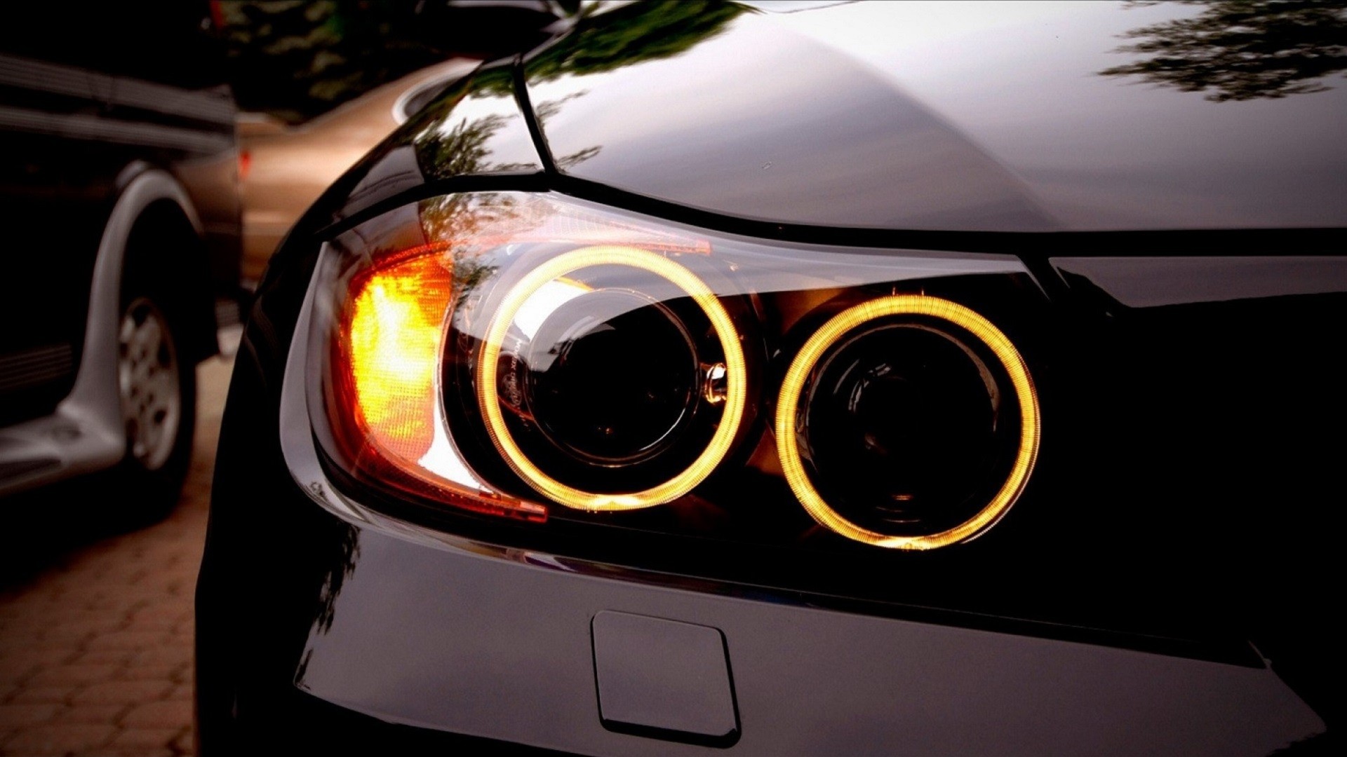 Black BMW car headlights with yellow rings HD Wallpaper