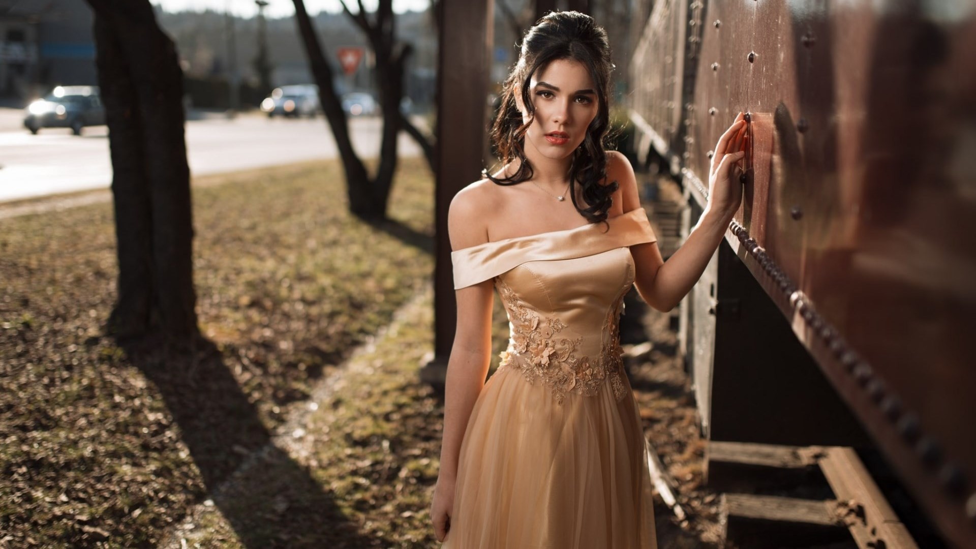 Woman in a golden dress by a train HD Wallpaper