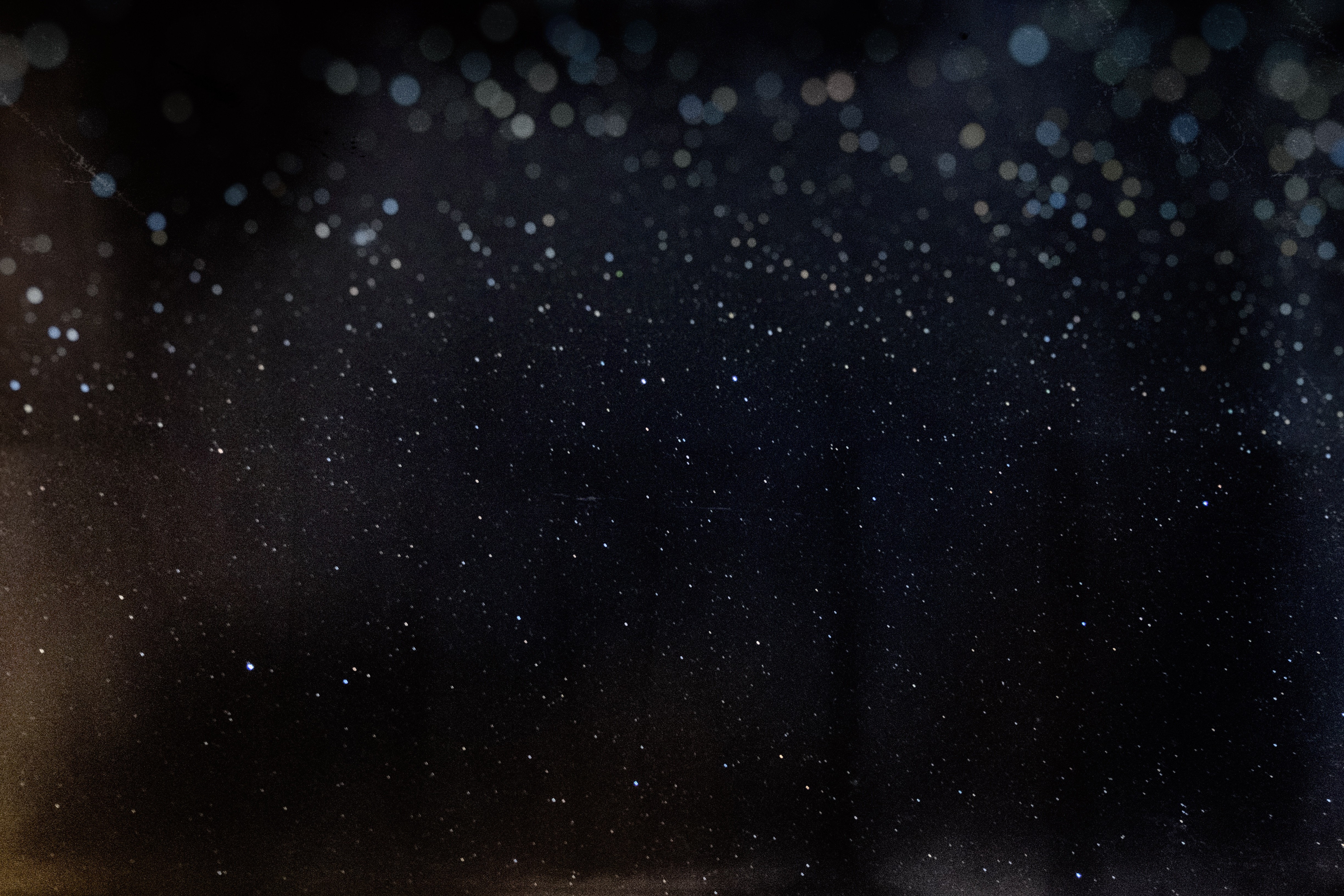 Dark background with scattered stars and bokeh lights HD Wallpaper