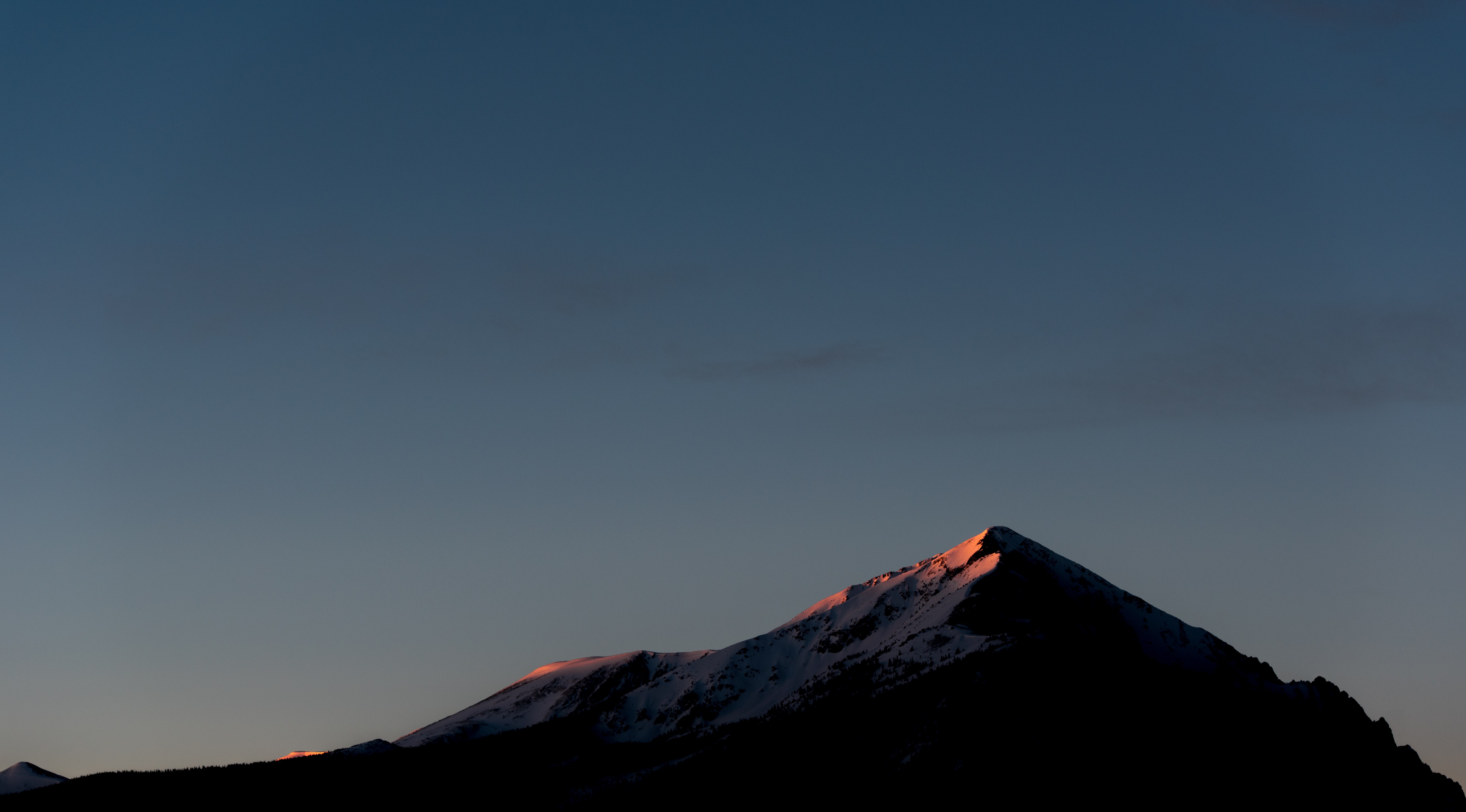 Snow-capped mountains at sunset HD Wallpaper
