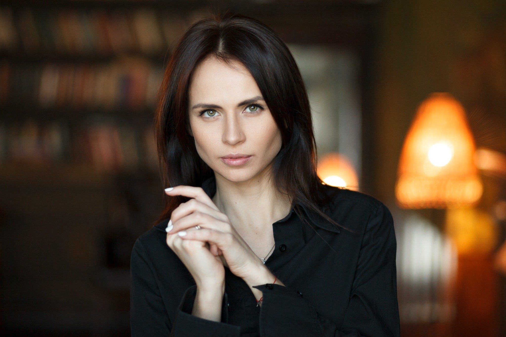 Woman in black shirt with bookshelves in background HD Wallpaper