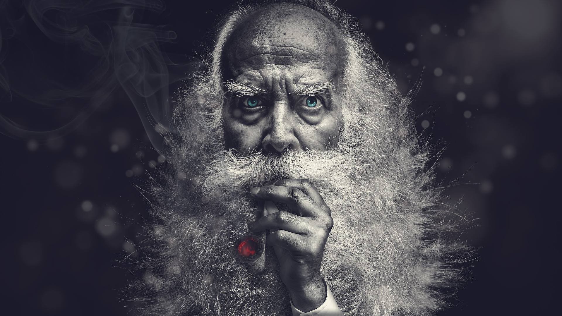 Old man with blue eyes smoking a pipe HD Wallpaper