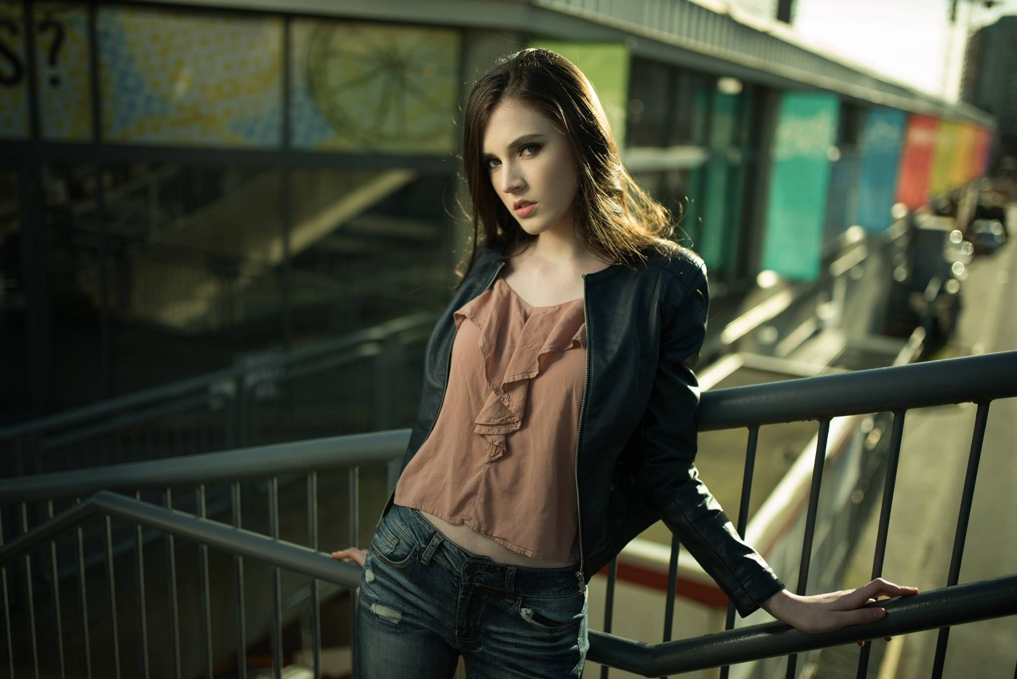 Woman in leather jacket and jeans on stairs HD Wallpaper
