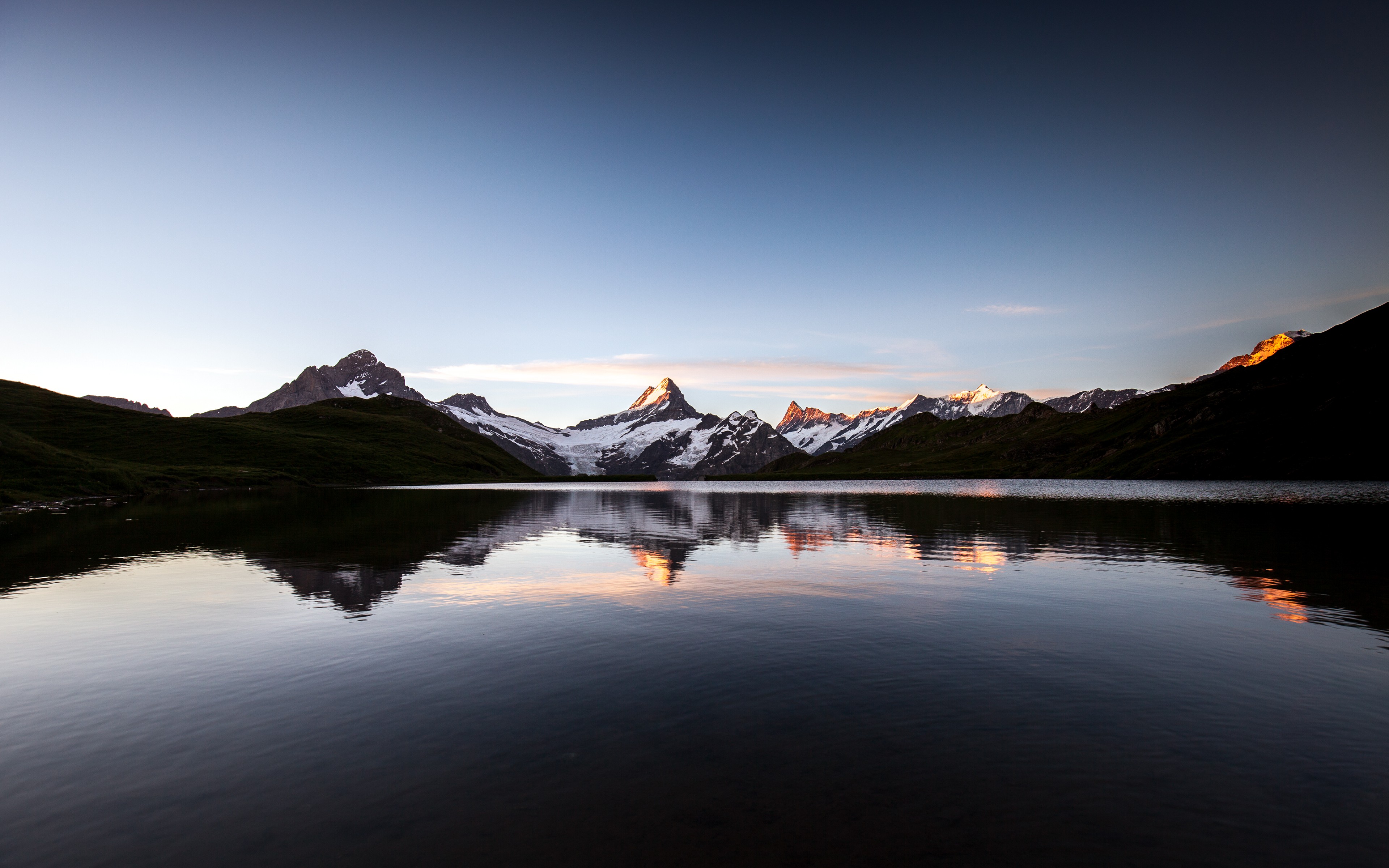 Lake reflecting snow-capped mountains at sunset HD Wallpaper
