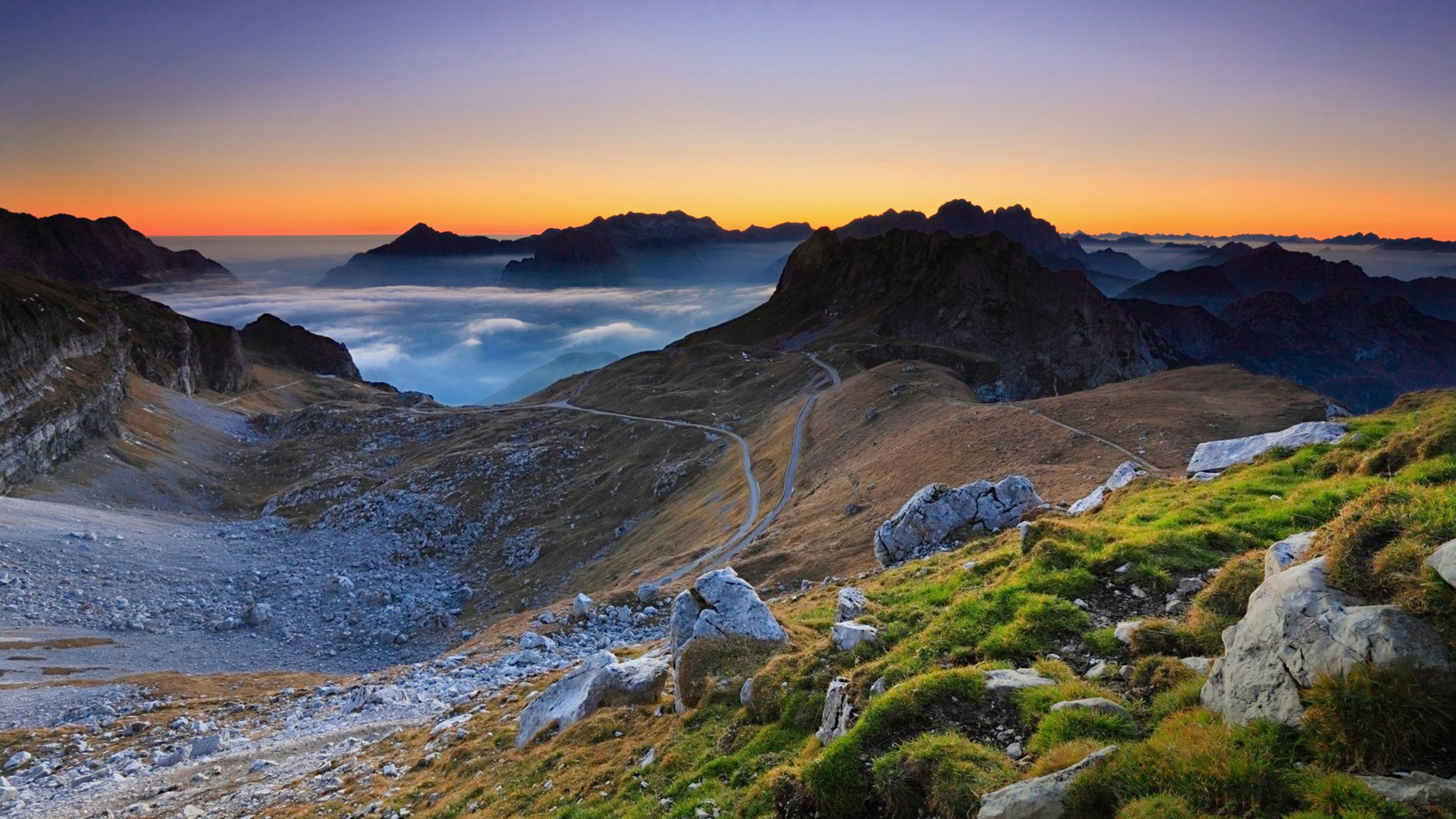 Mountains at sunset with clouds and fog HD Wallpaper