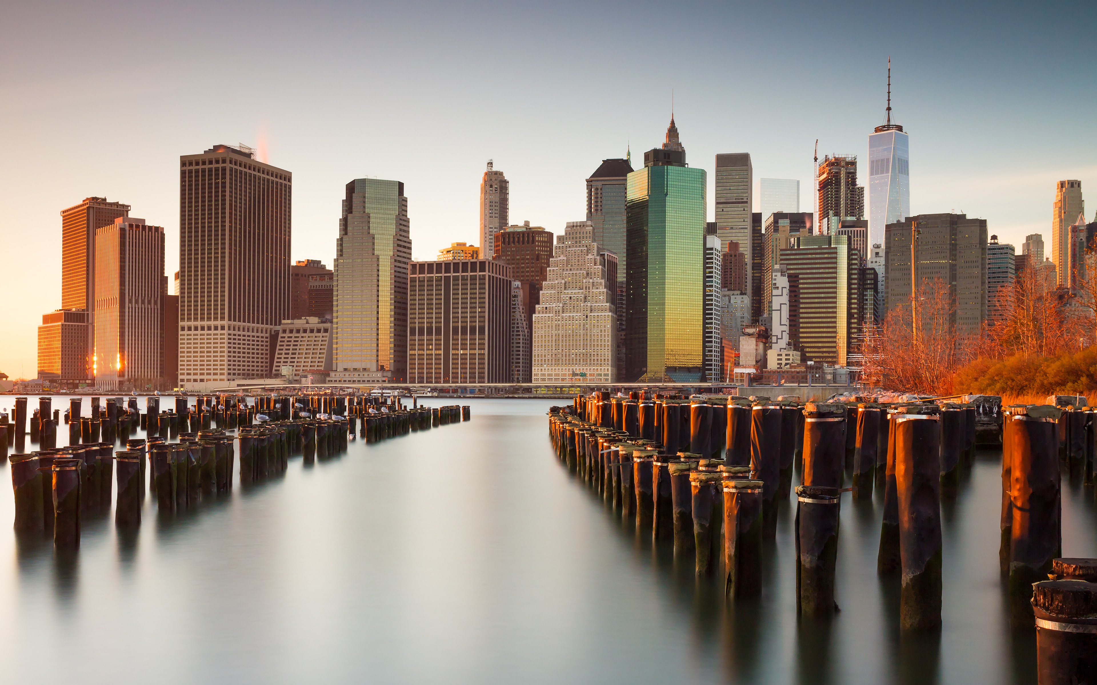 New York City skyline at sunset with piers HD Wallpaper