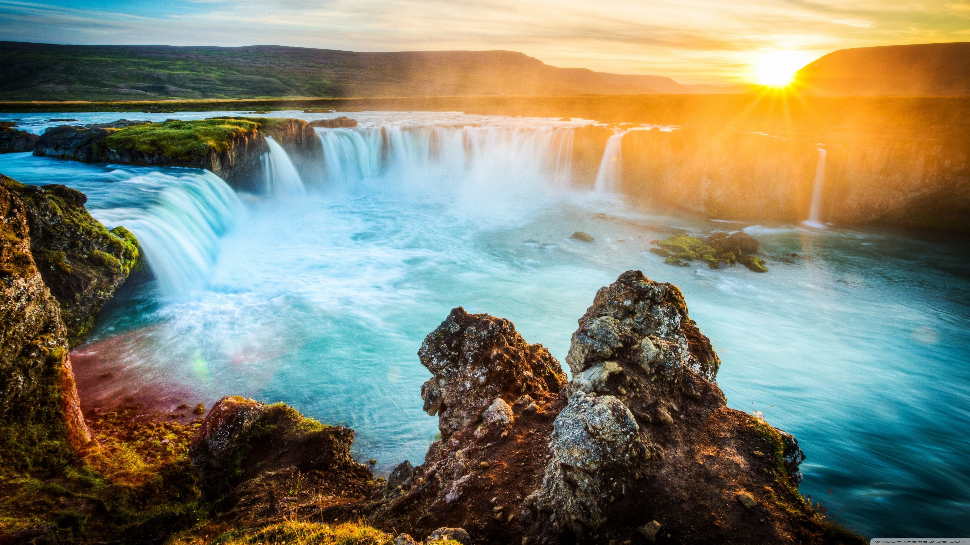 Sunset over a waterfall in Iceland HD Wallpaper
