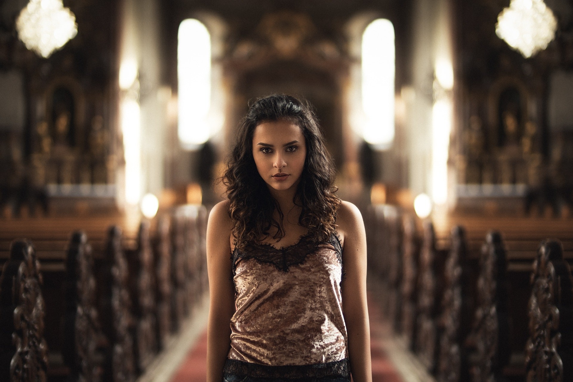 Woman with curly hair in a church HD Wallpaper