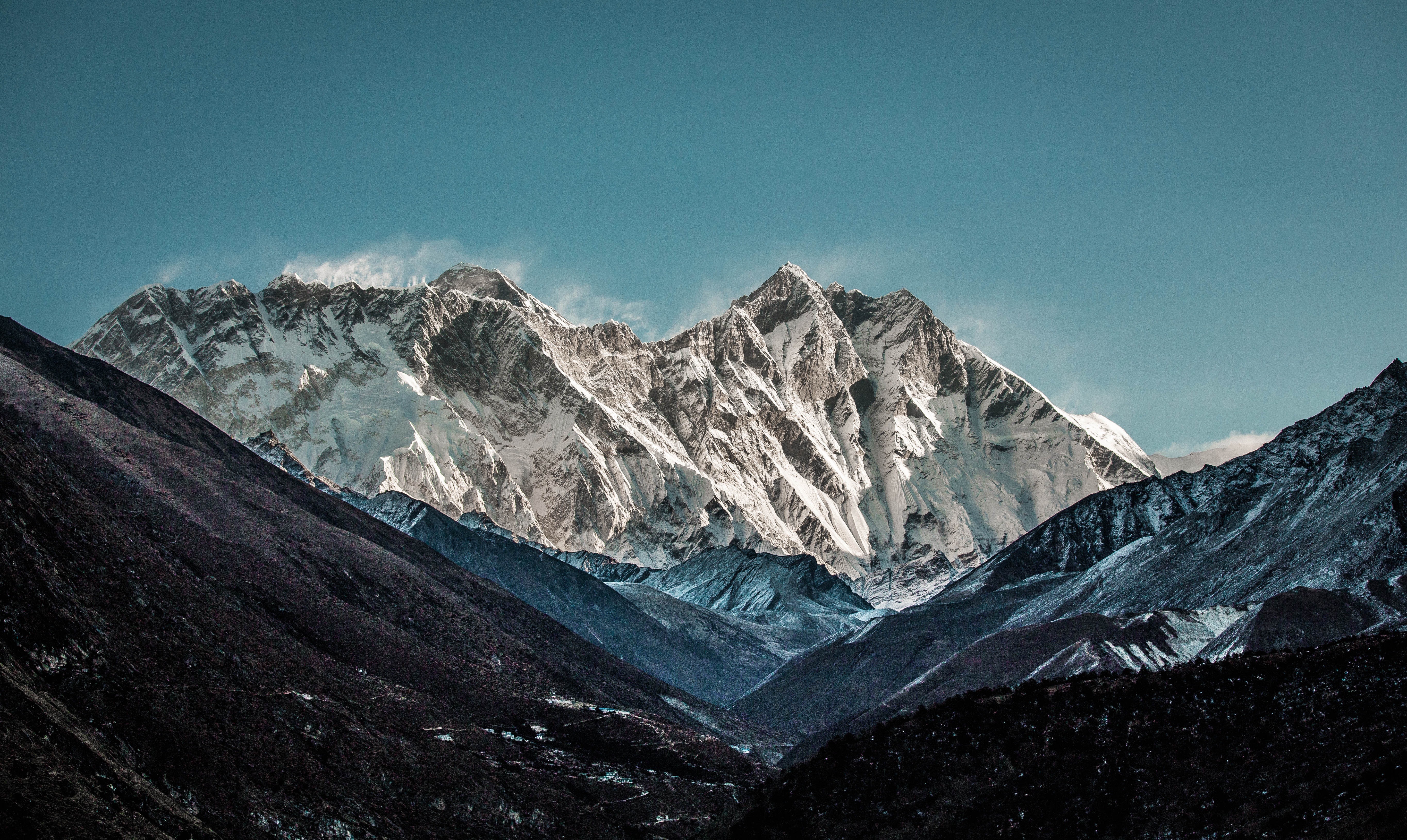 Snow-capped mountains under a clear blue sky HD Wallpaper