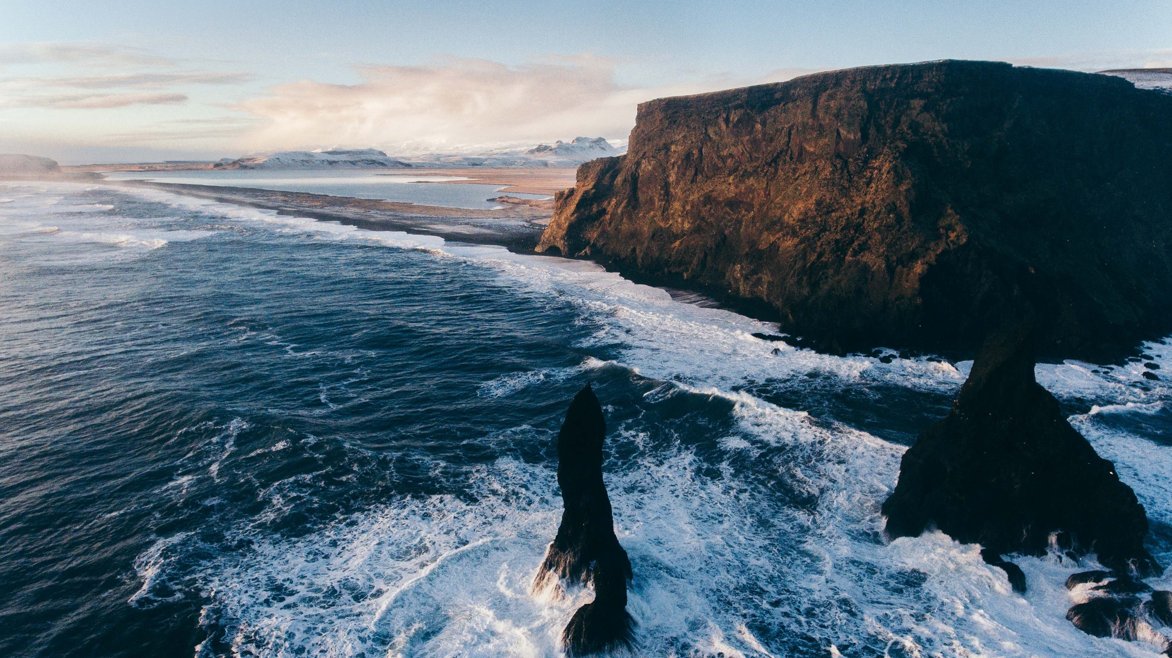 Ocean waves crashing against cliffs and rock formations HD Wallpaper