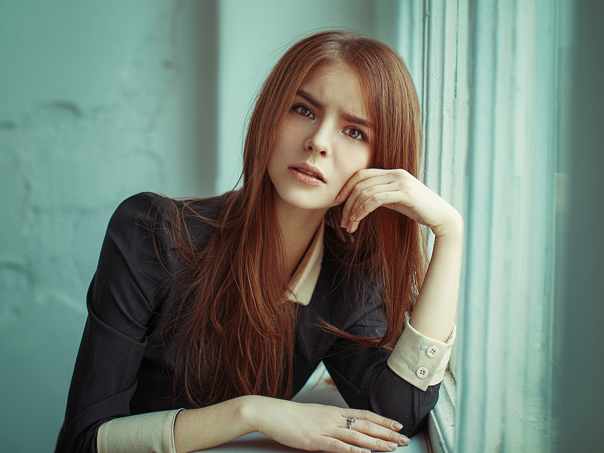 Young woman with red hair by a window HD Wallpaper