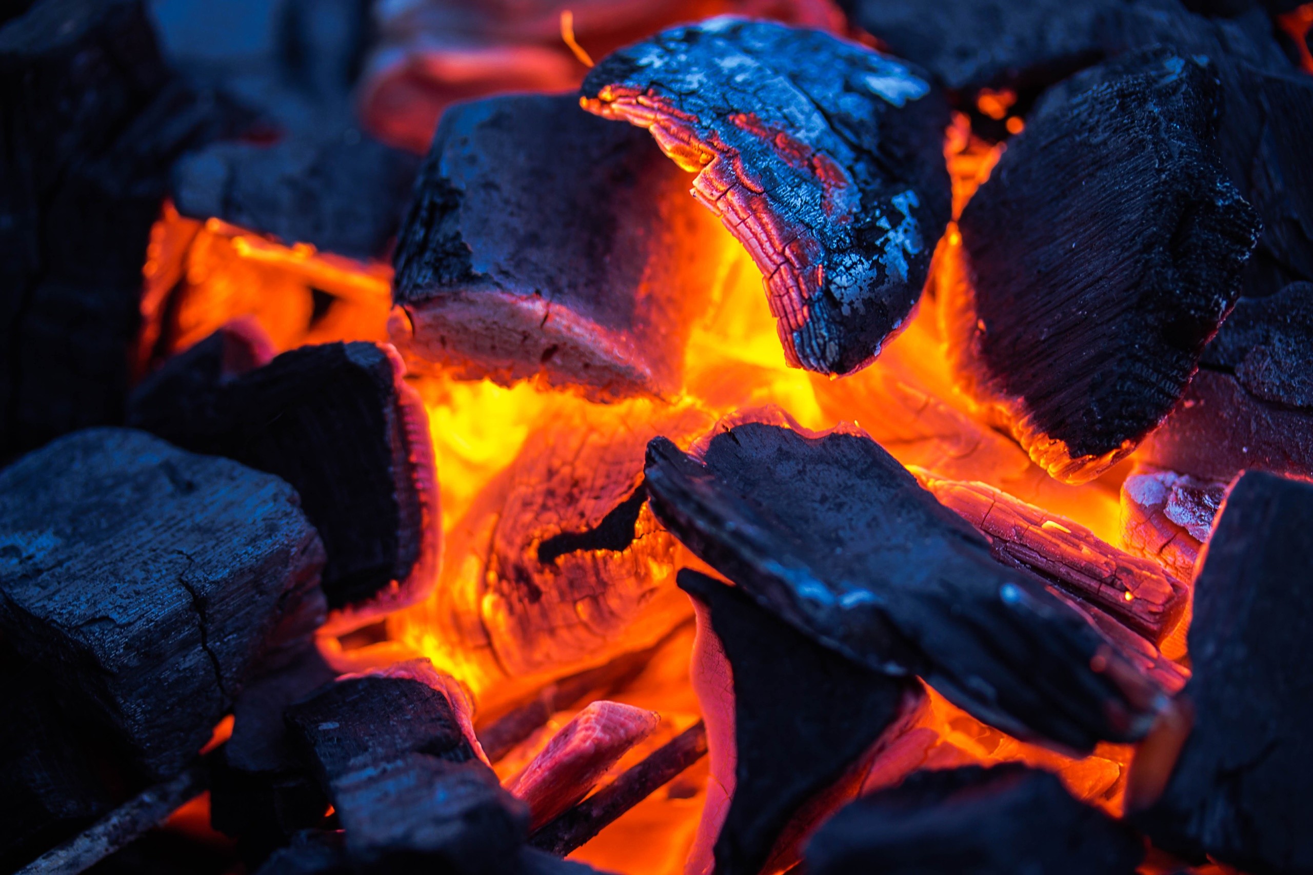 Close-up of glowing hot coals and embers HD Wallpaper