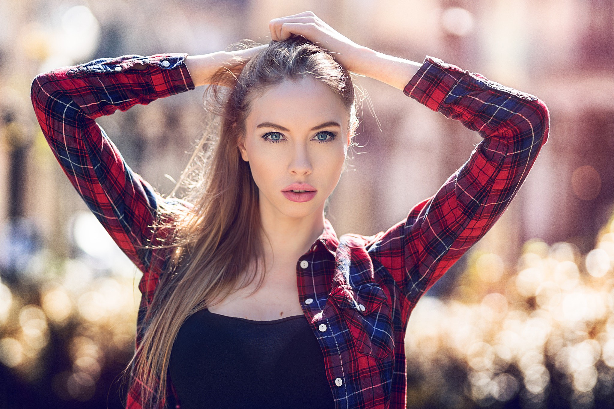 Woman with hands on head wearing a plaid shirt HD Wallpaper