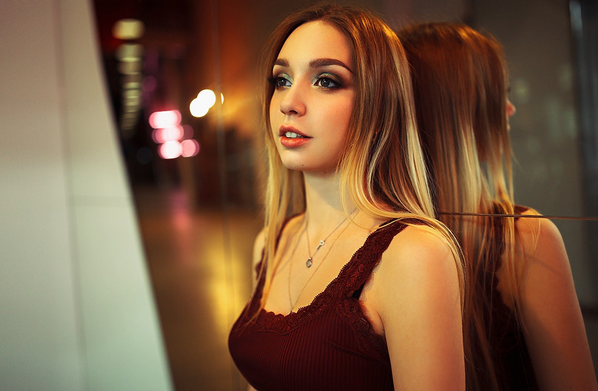 Woman with necklace looking away in front of a mirror HD Wallpaper