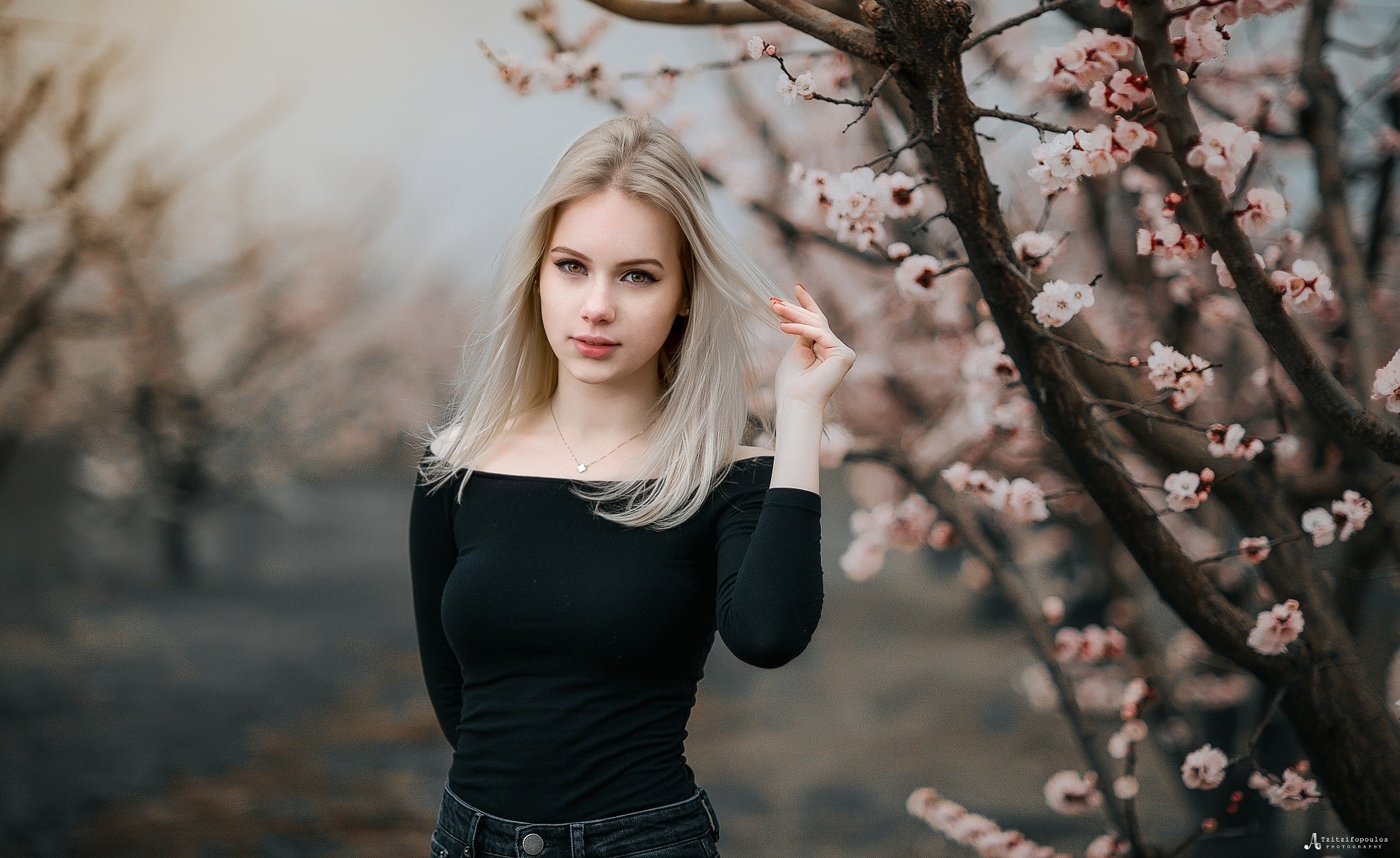 Woman with blonde hair in a black off-the-shoulder top outdoors HD Wallpaper