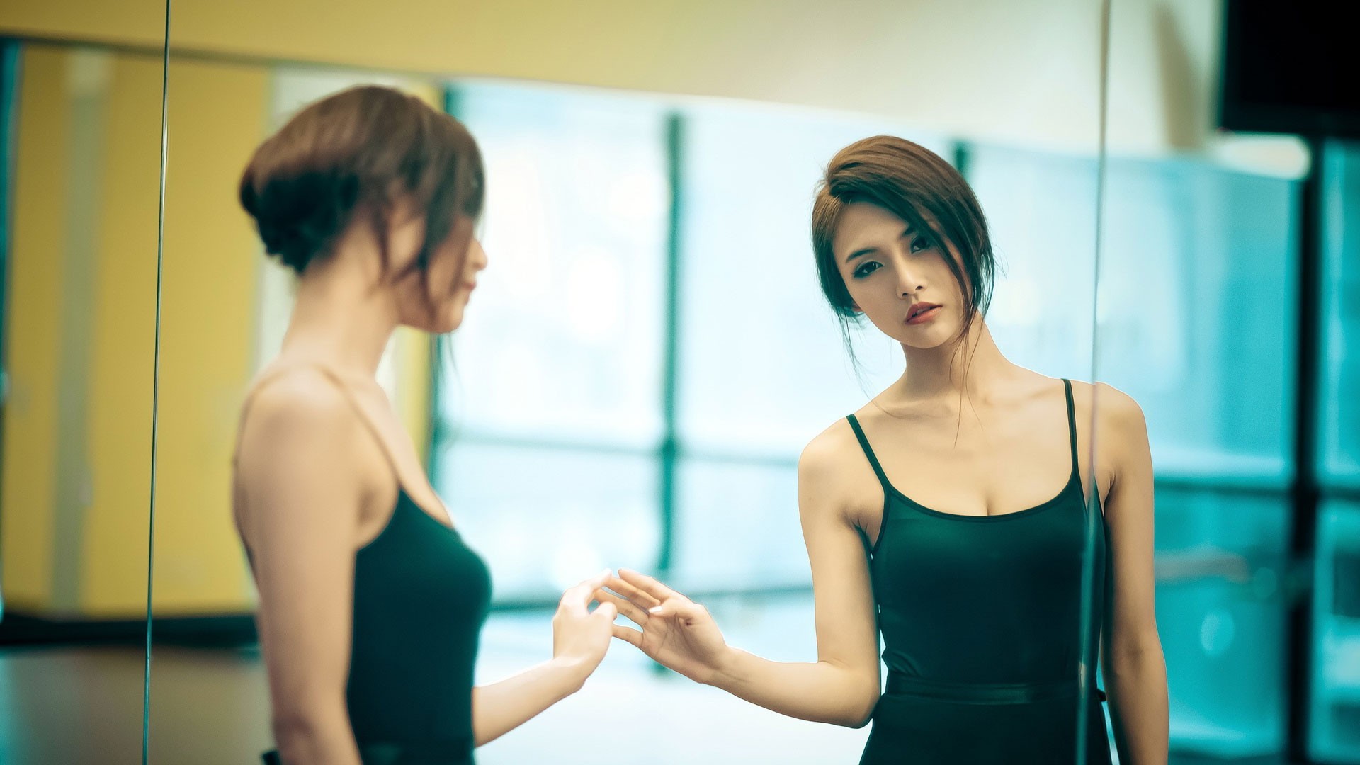 Asian woman in black dress looking in mirror HD Wallpaper
