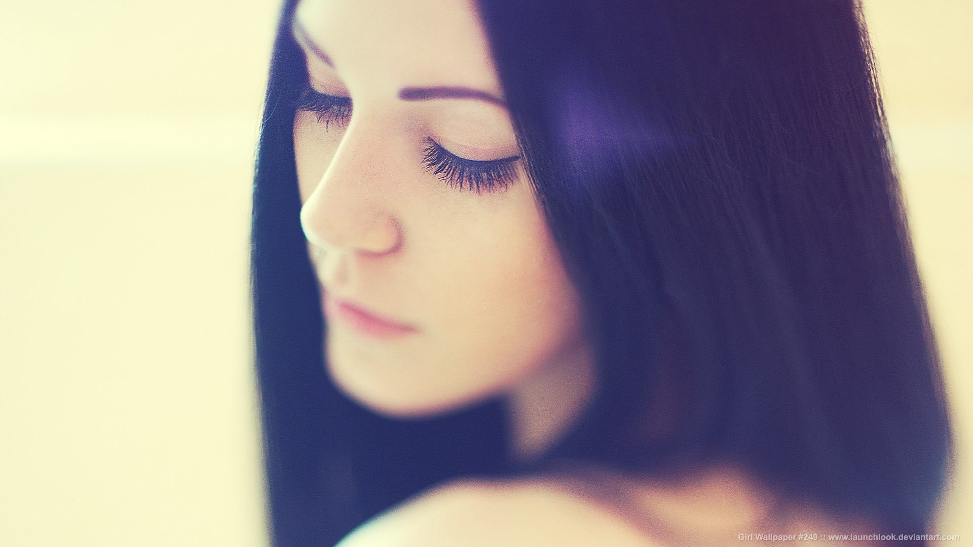 Woman with dark hair looking down HD Wallpaper