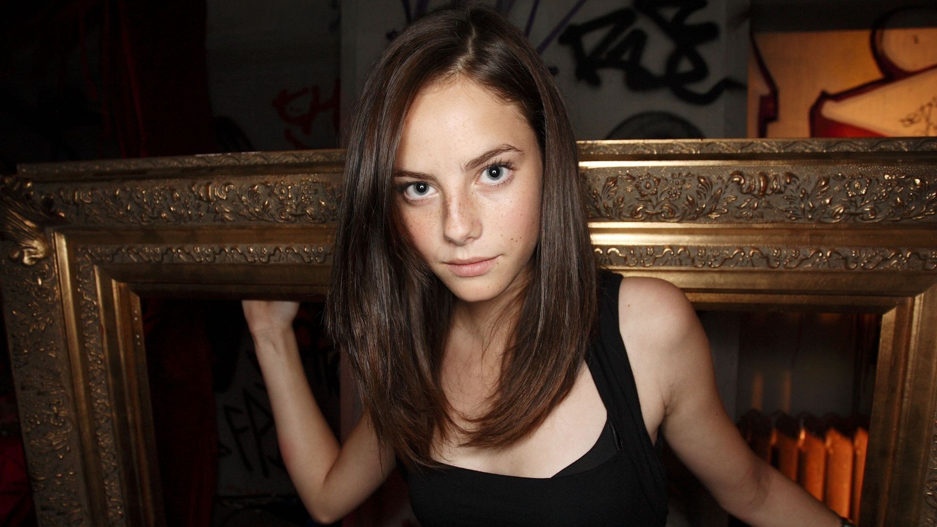 Kaya Scodelario framed by a golden ornate border HD Wallpaper