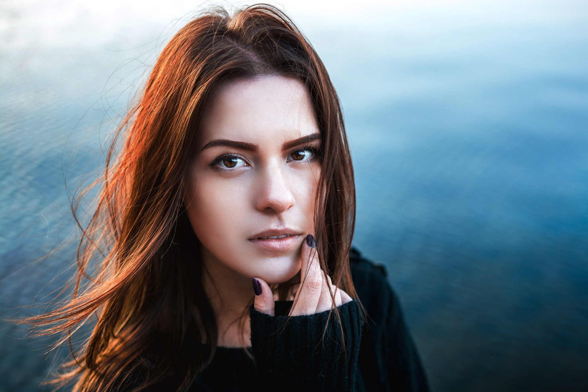 Woman with brown hair by the water HD Wallpaper