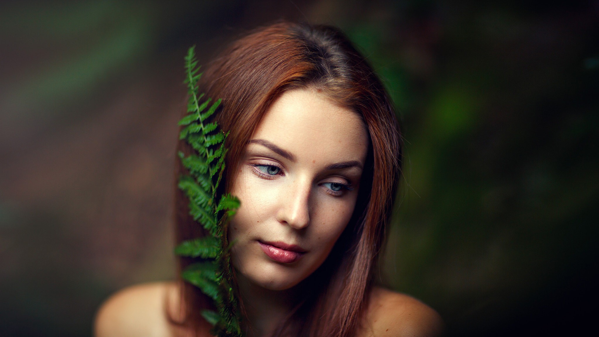 Woman with fern in forest portrait HD Wallpaper
