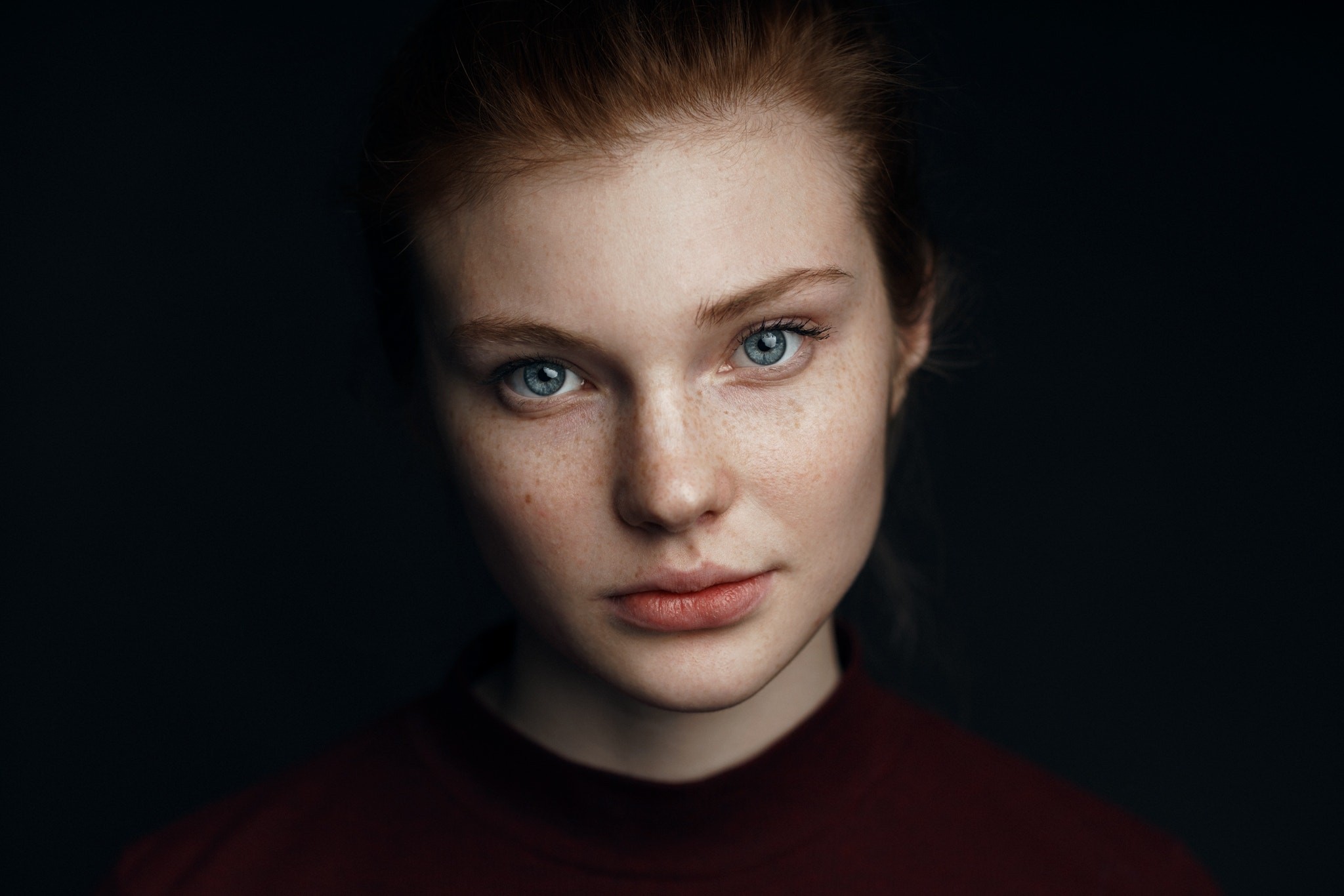 Portrait of a young woman with freckles and blue eyes HD Wallpaper
