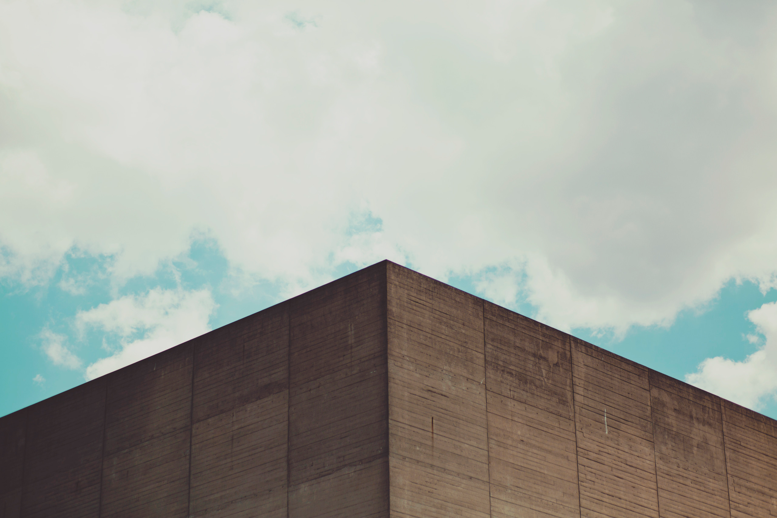 Minimalist concrete building corner against sky HD Wallpaper