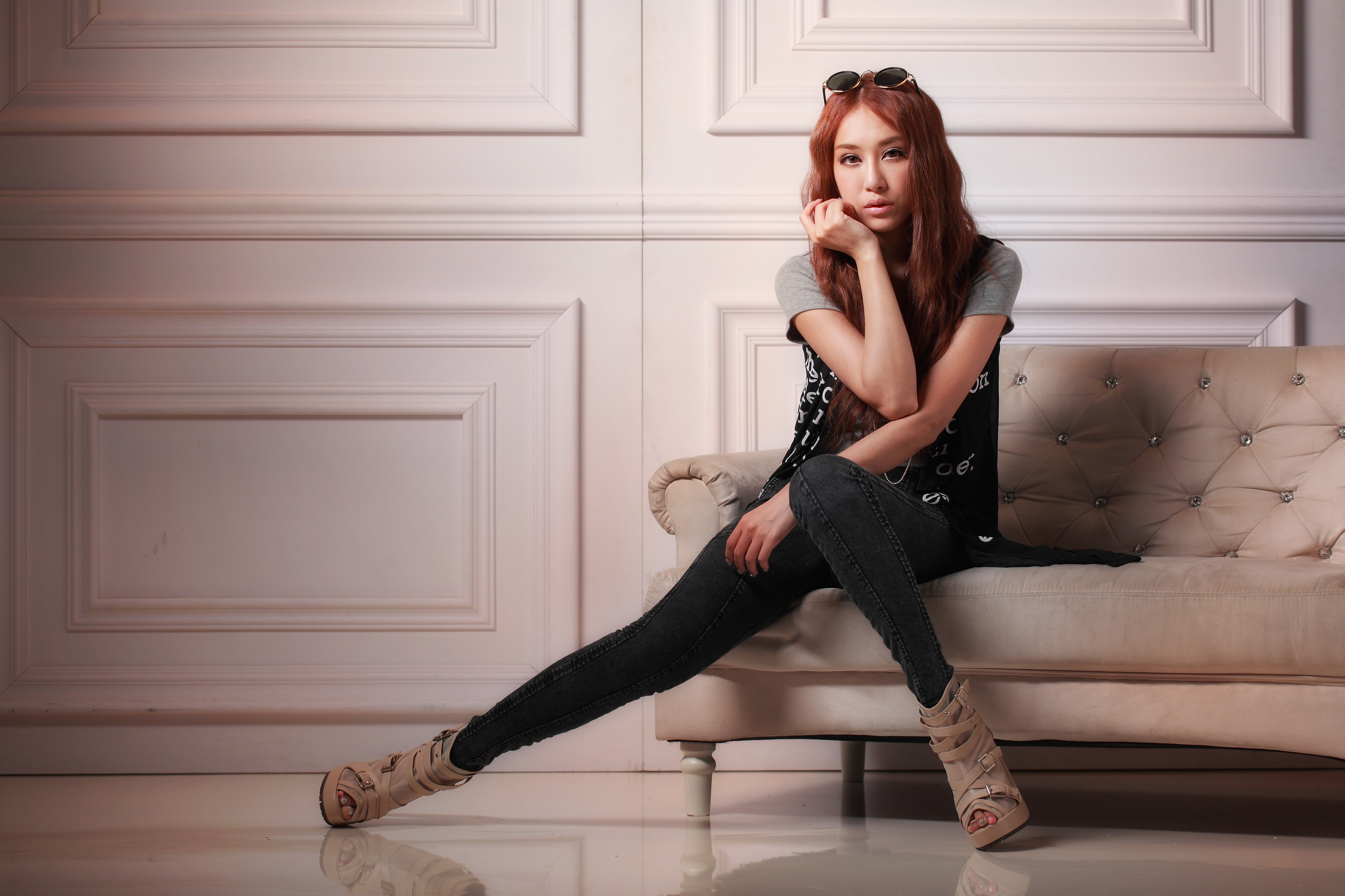 Asian model sitting on a couch HD Wallpaper