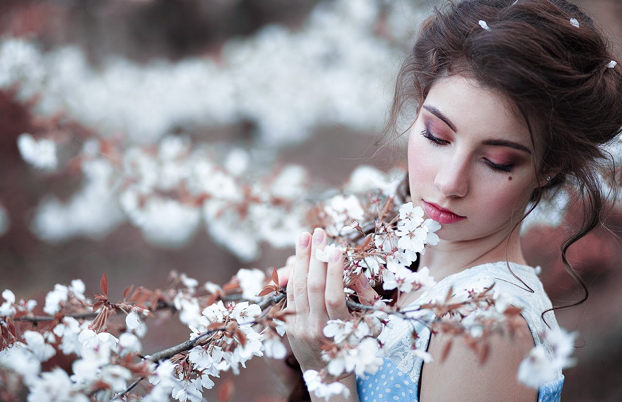 Woman smelling white flowers in spring HD Wallpaper