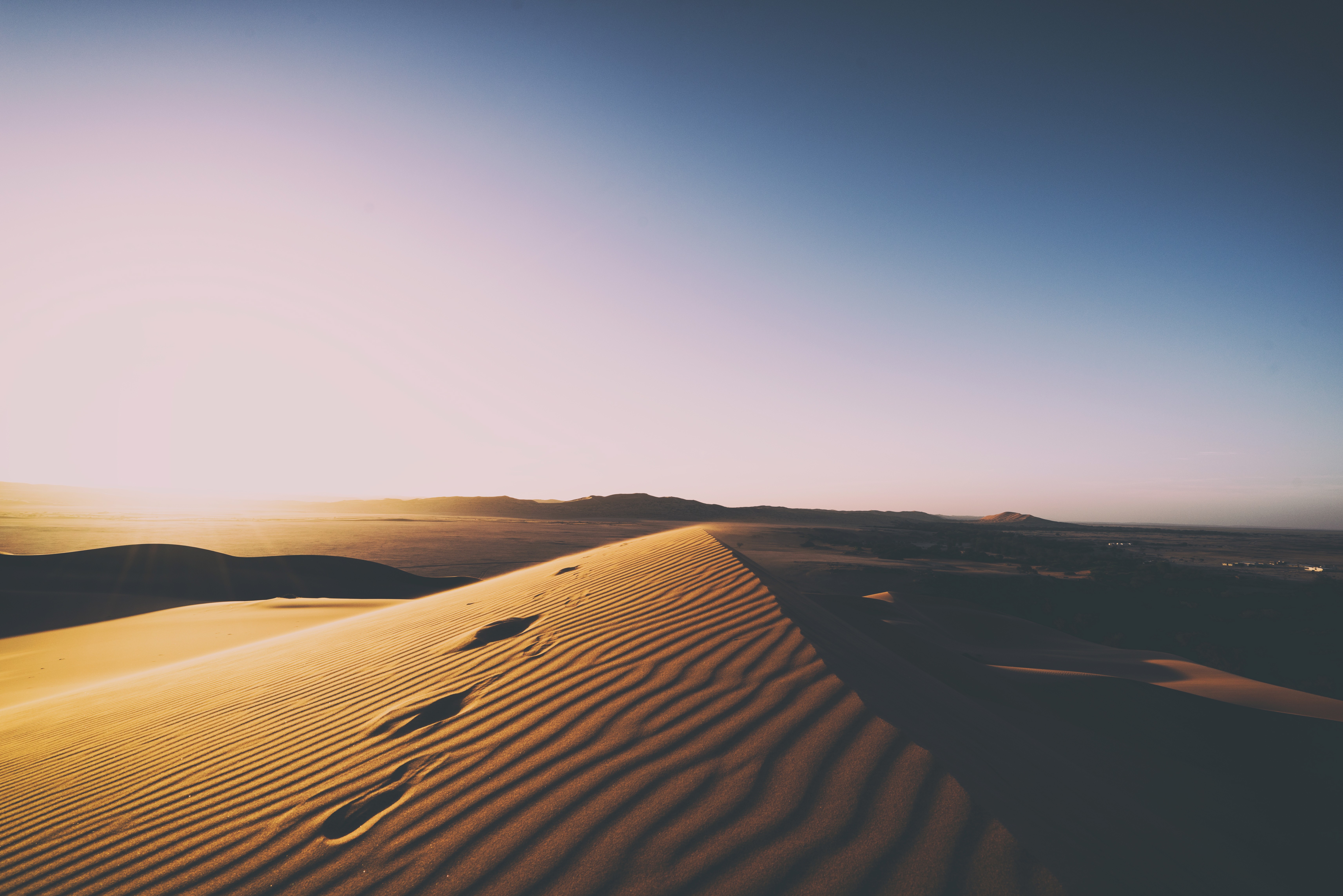 Footprints on a sand dune at sunset HD Wallpaper