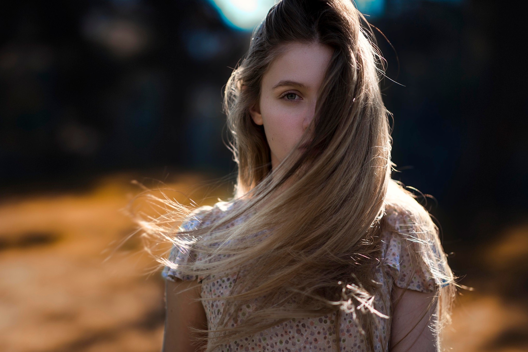 Woman with blonde hair in her face outdoors HD Wallpaper