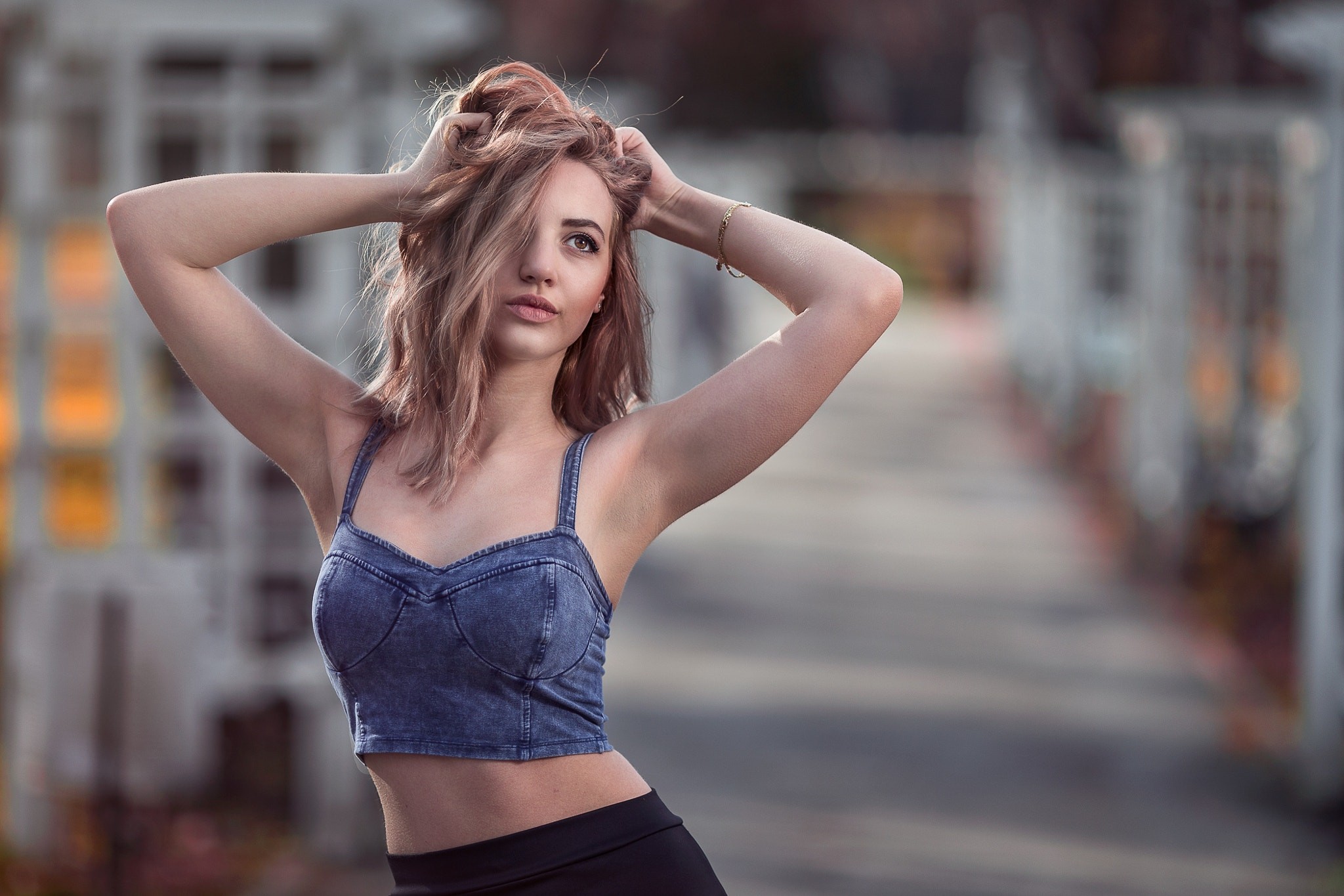 Woman with hands on head in denim top HD Wallpaper