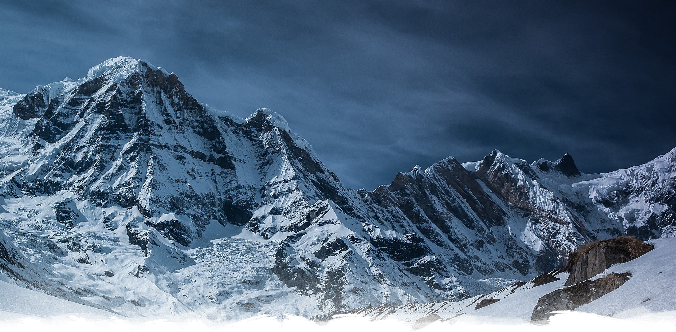 Snowy Annapurna mountain range under a dark sky HD Wallpaper