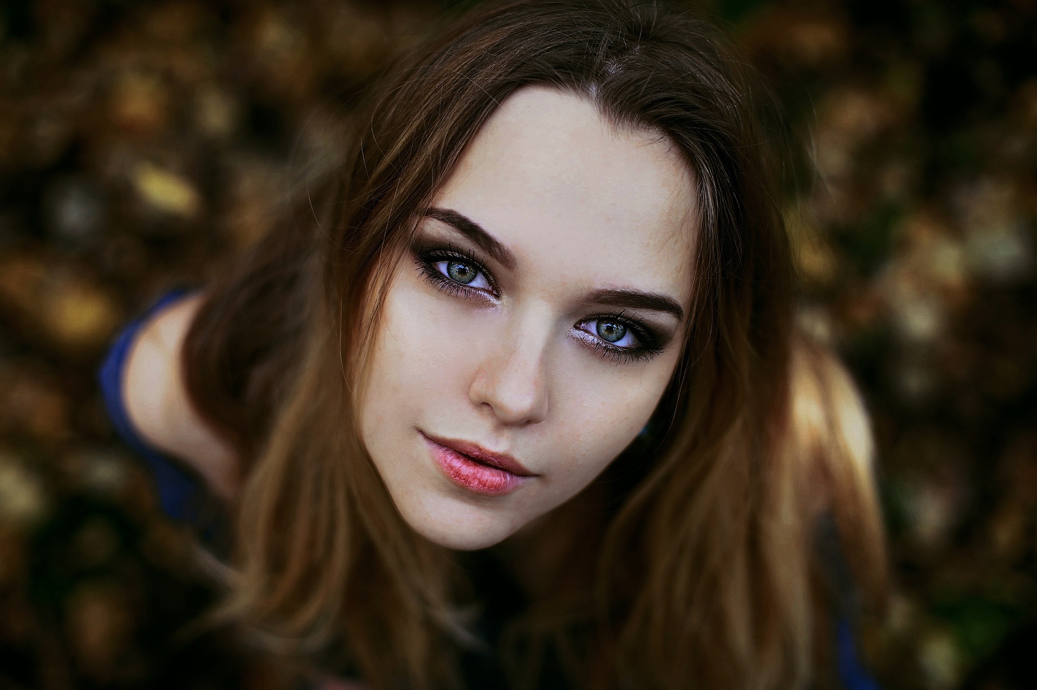 Young woman with long brown hair and makeup HD Wallpaper