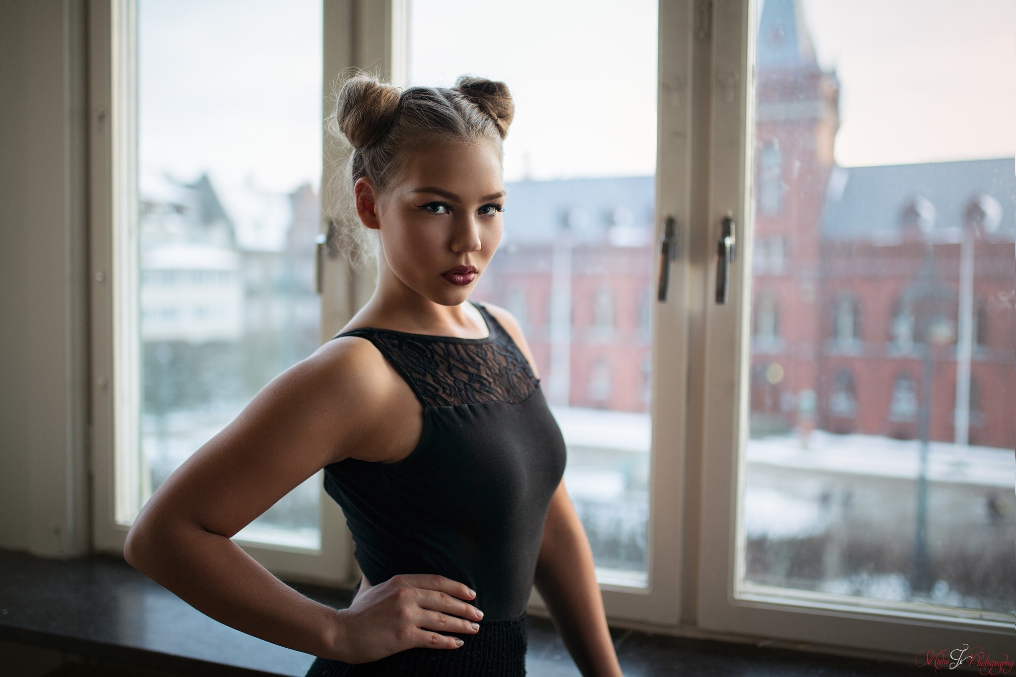 Woman with buns posing by window HD Wallpaper